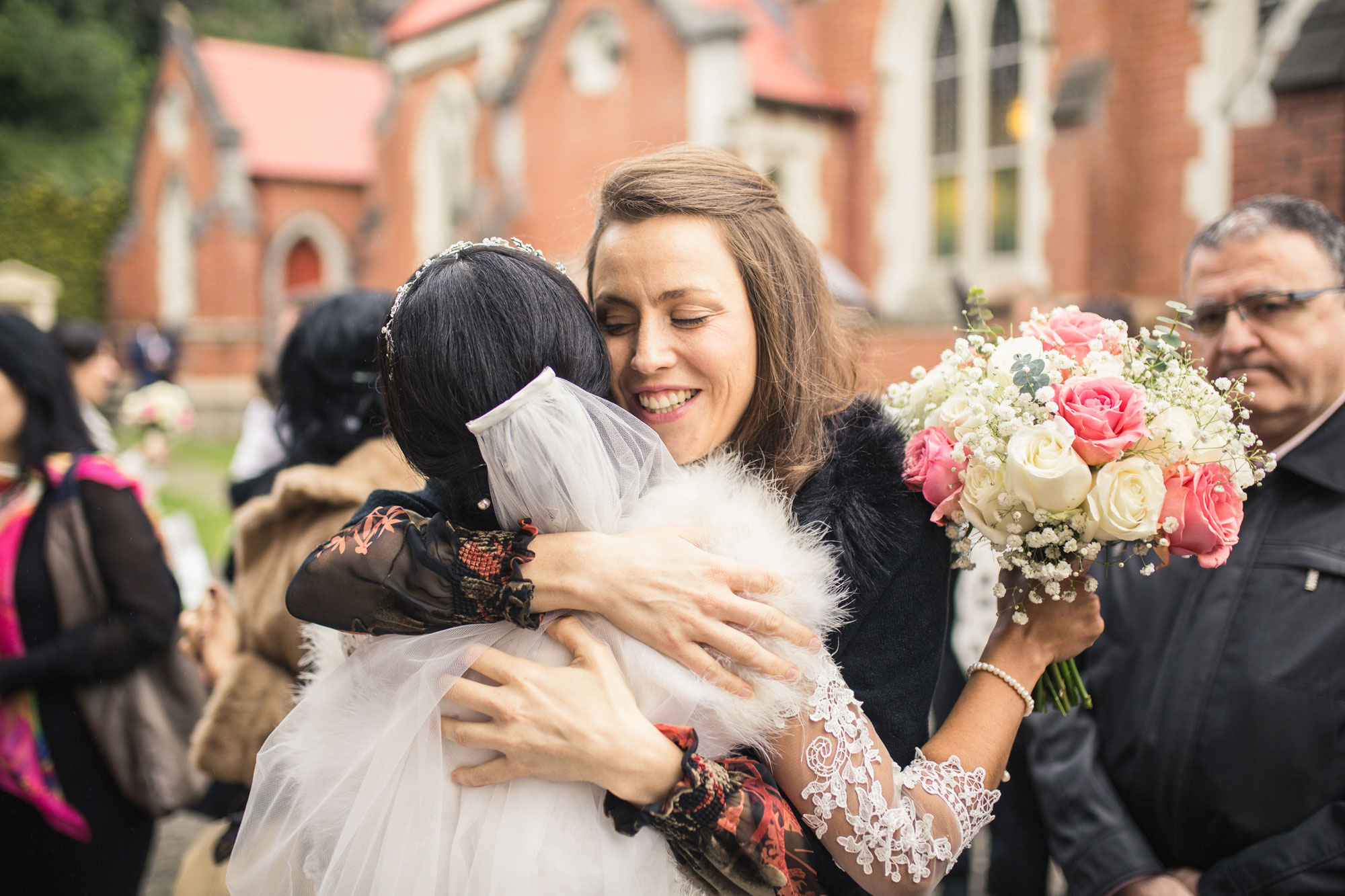 guest and bride embrace