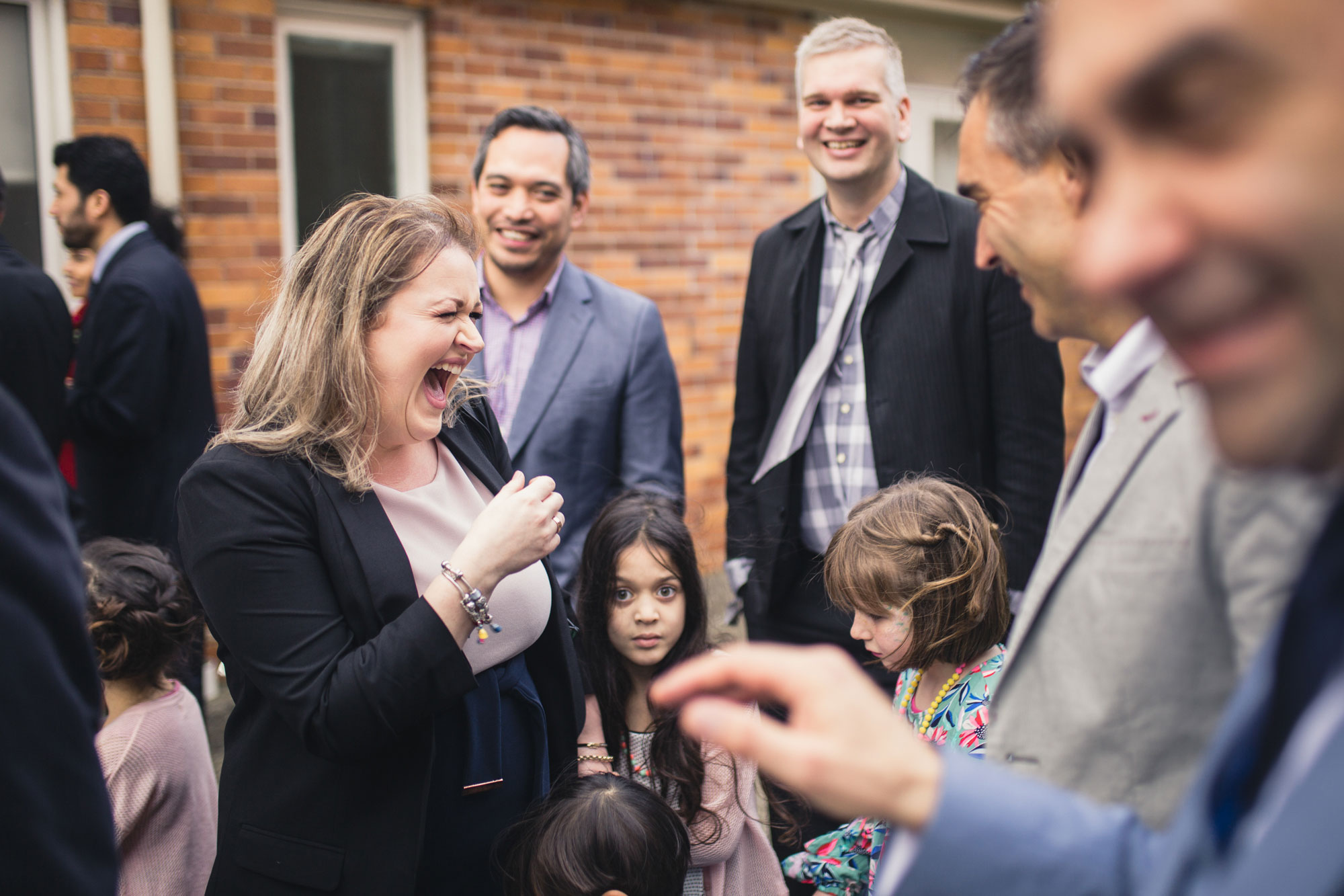 wedding guest laughing at a joke