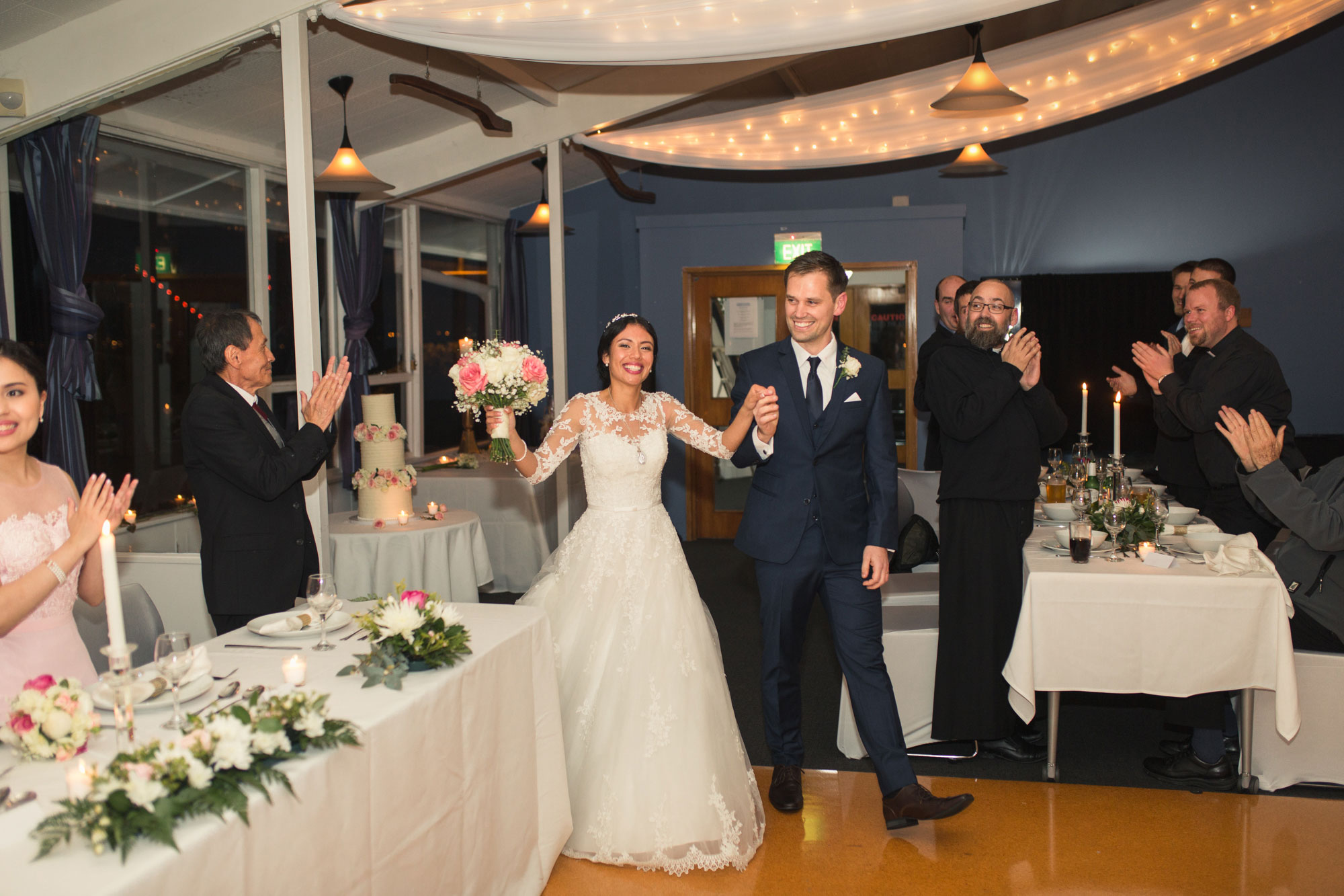 bride and groom entering wedding reception