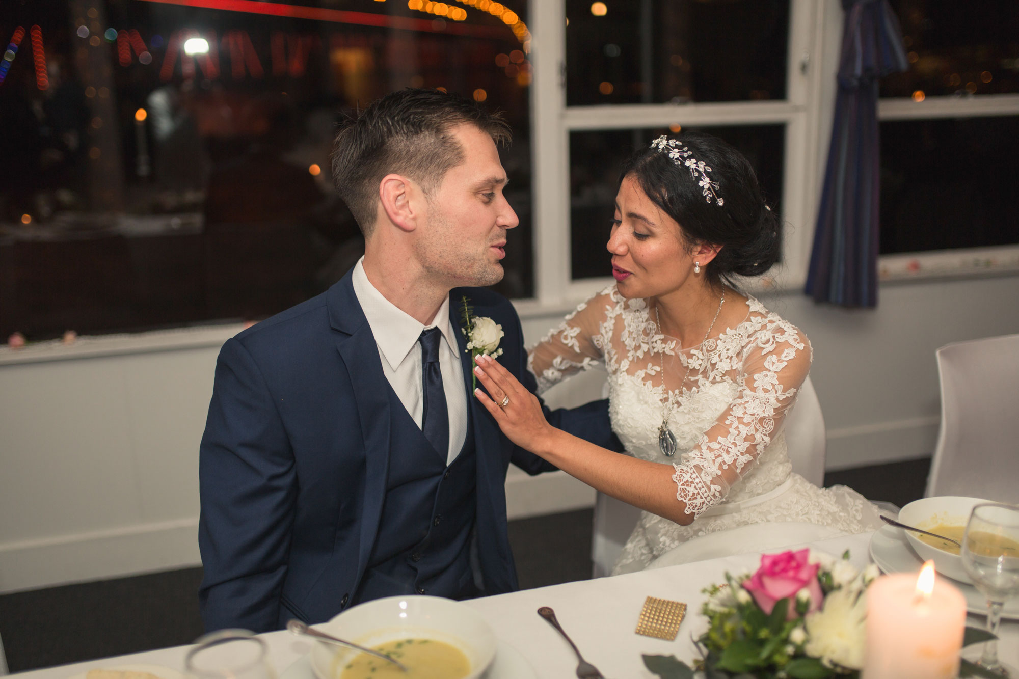 bride and groom interacting at wedding reception