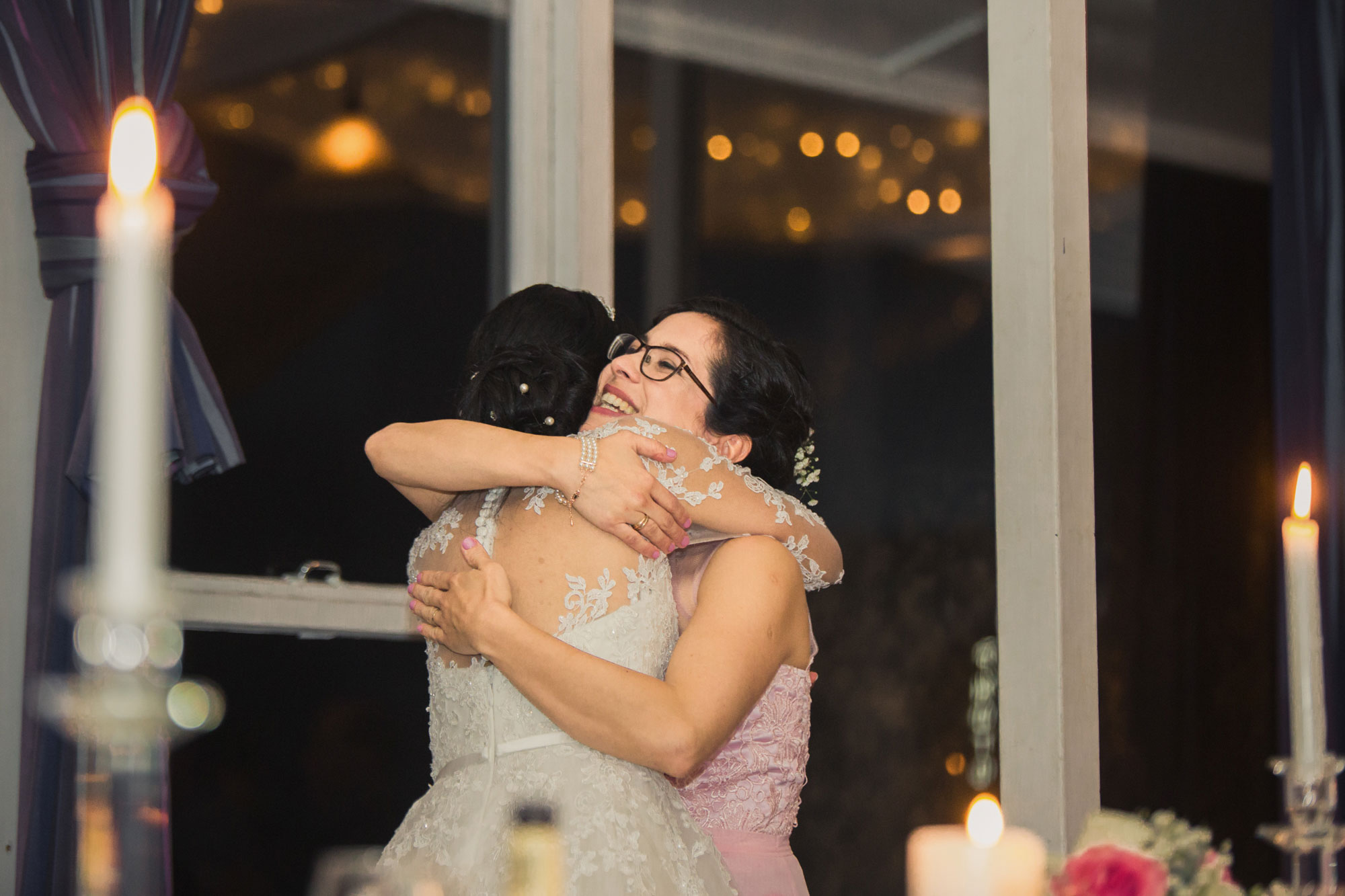 sister hugging the bride