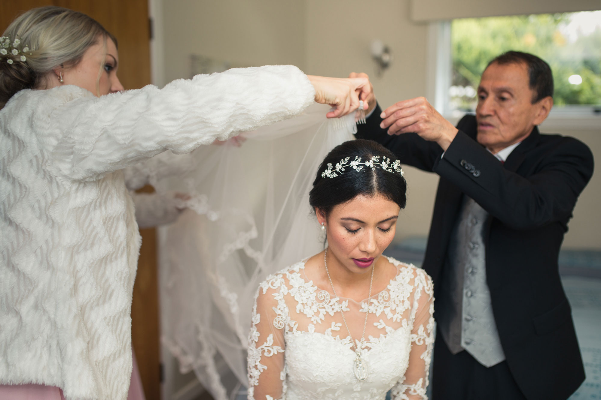 bride putting on veil