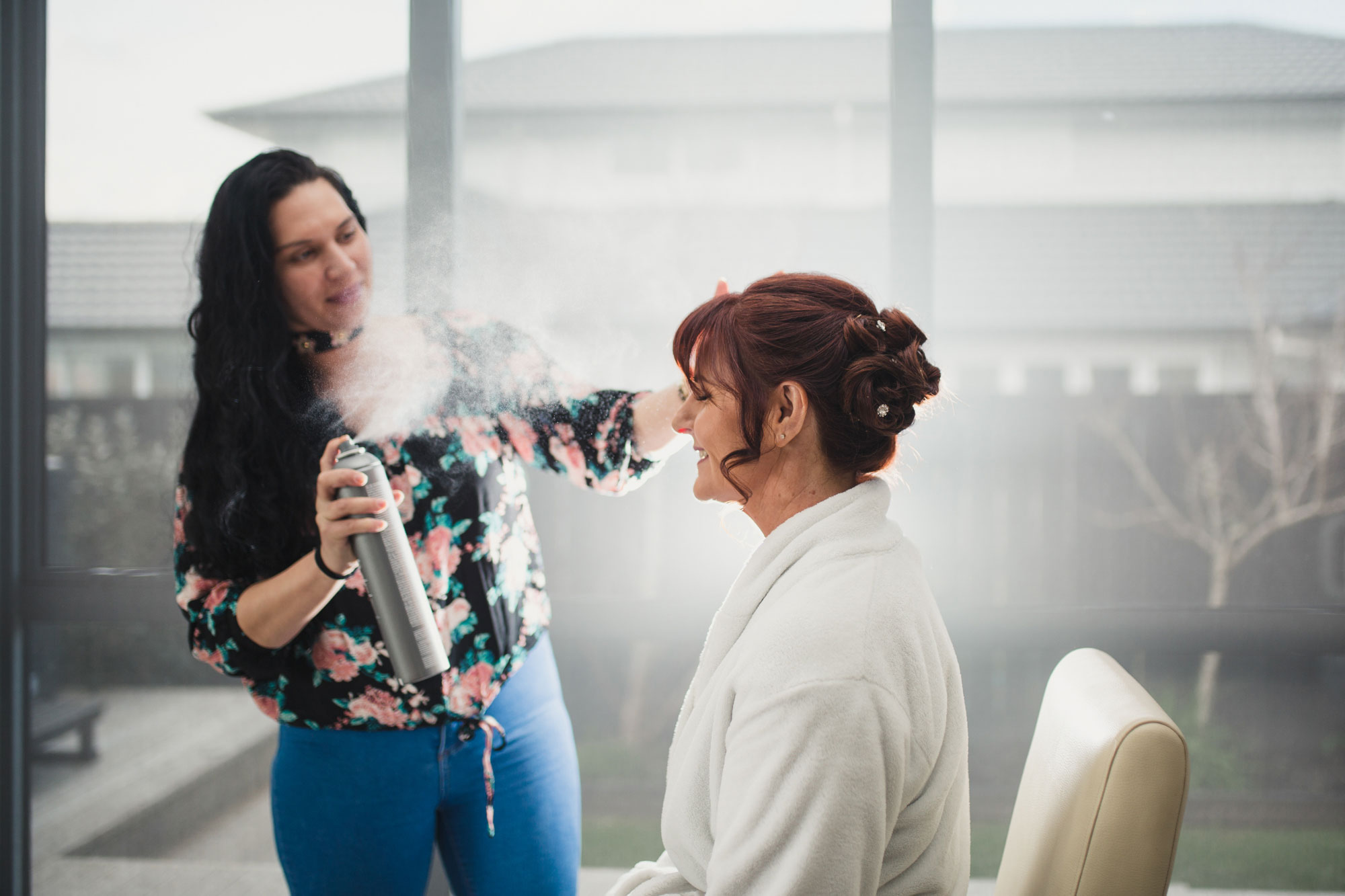 bride getting hair spray