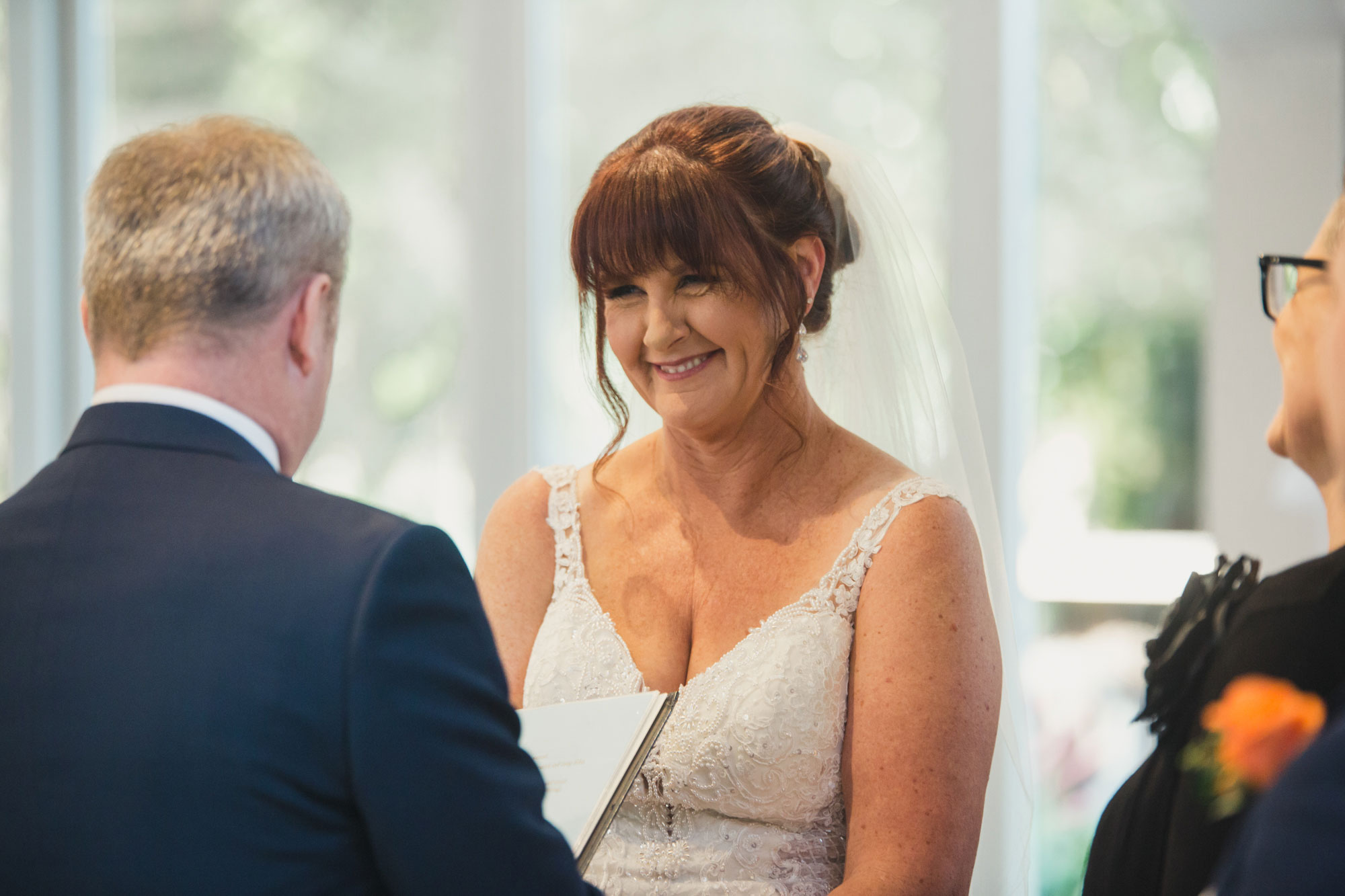 bride looking at groom vows