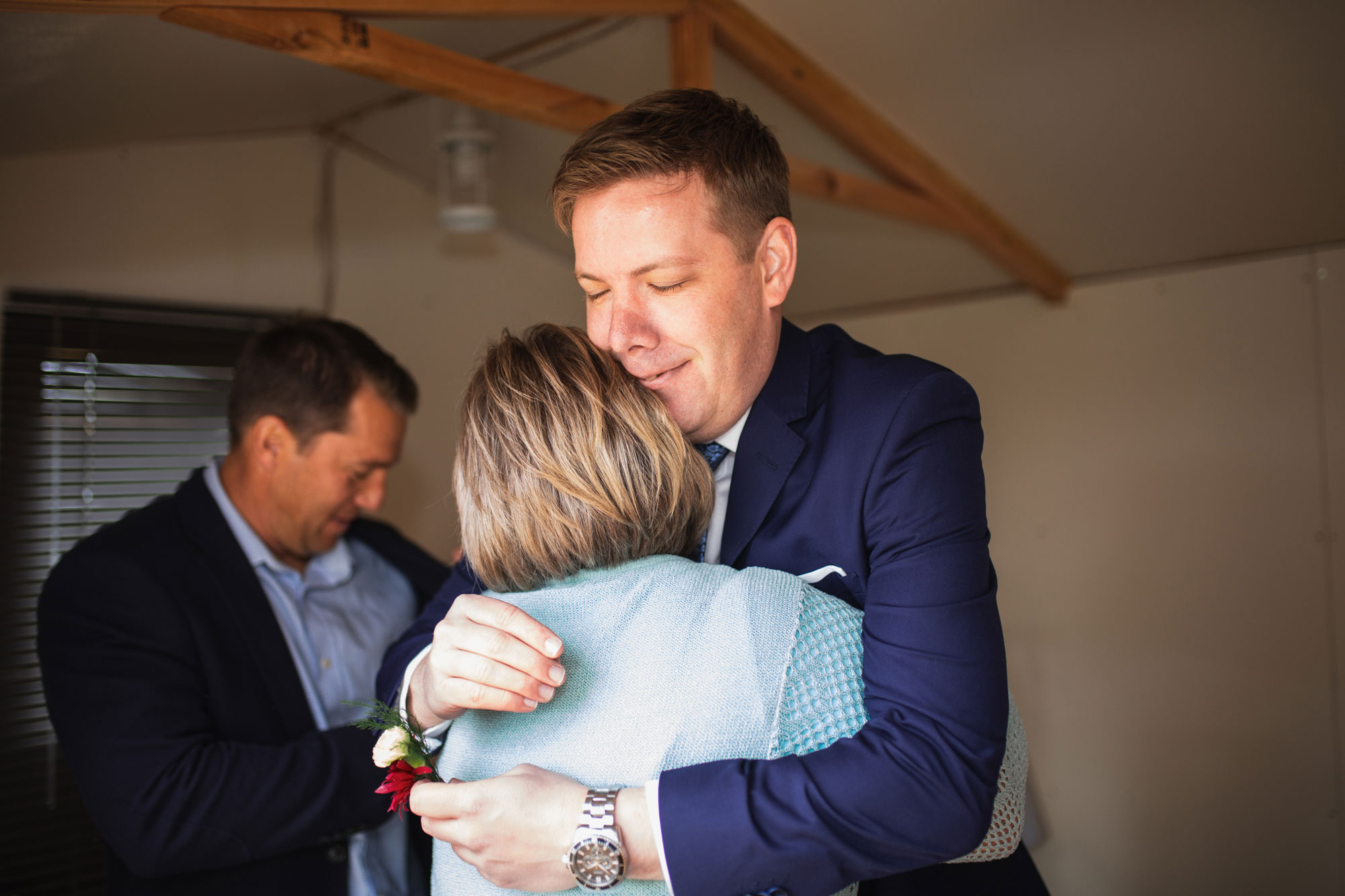 groom hugging