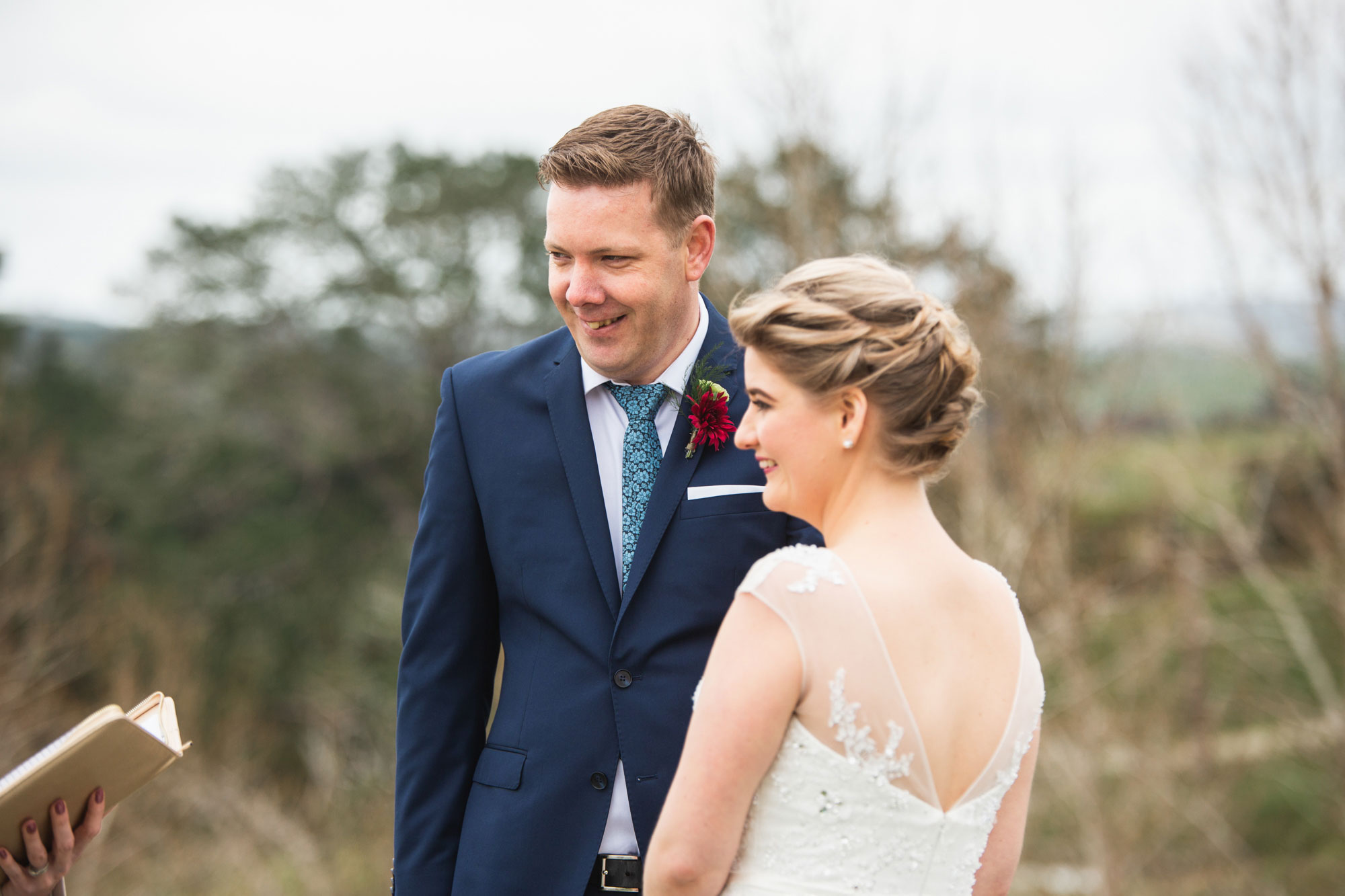 bride and groom listening to celebrant