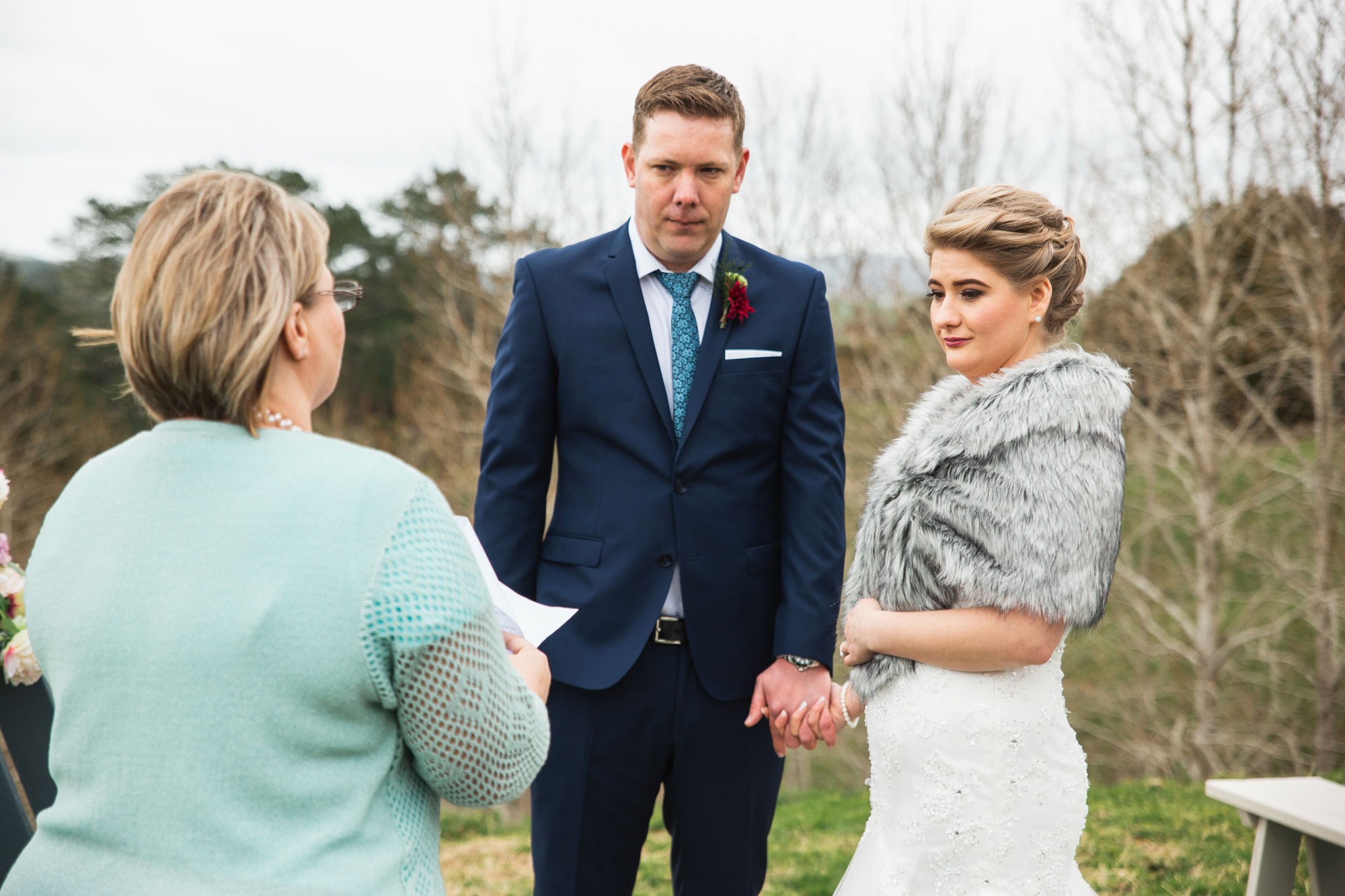 bride and groom listening to mother speech