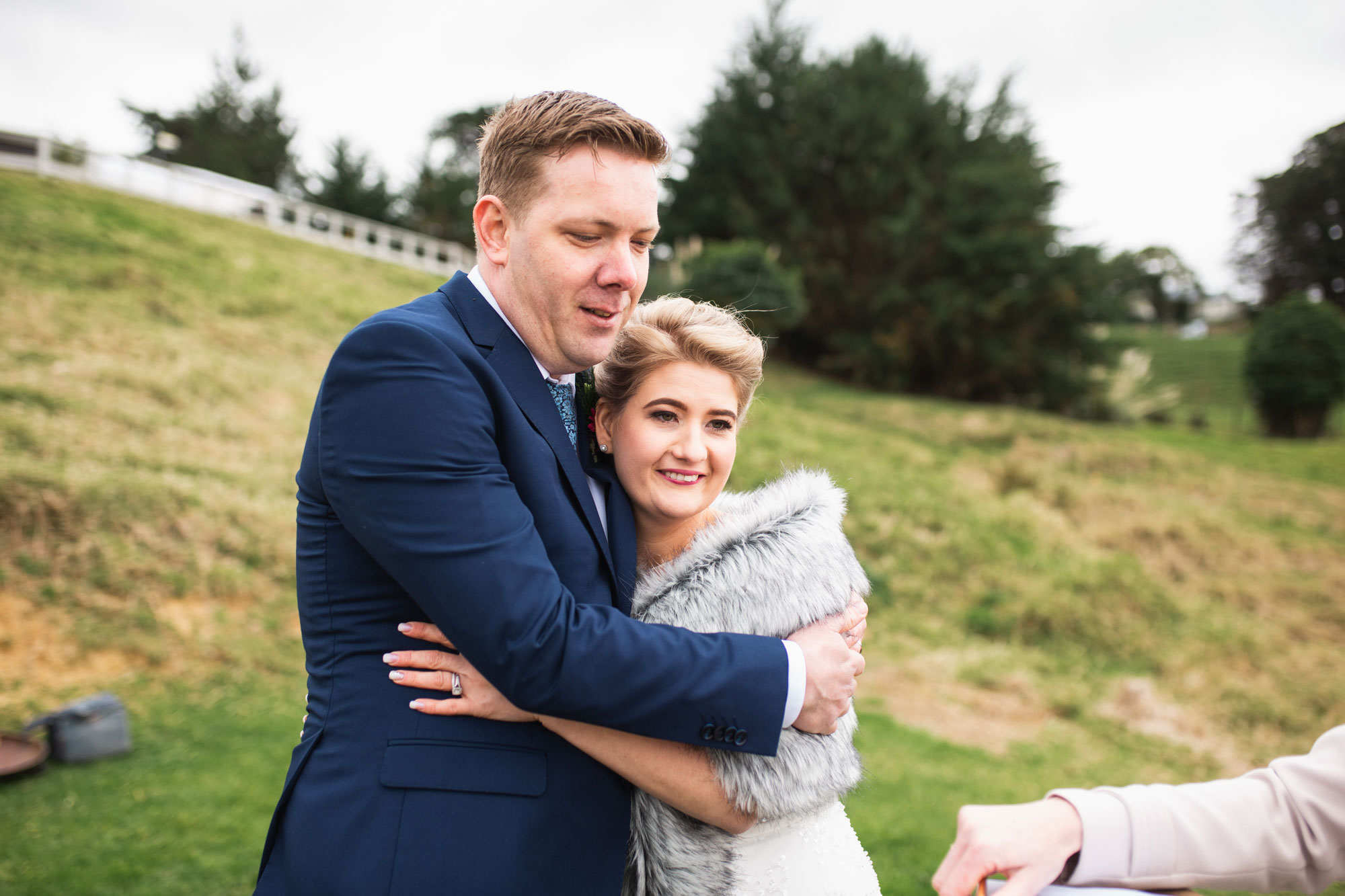 bride and groom hugging