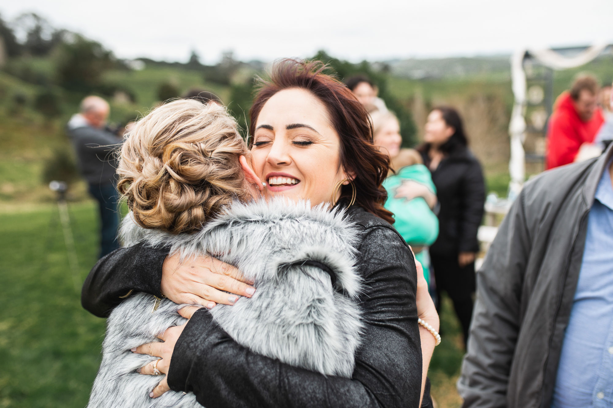 wedding guest hugging bride