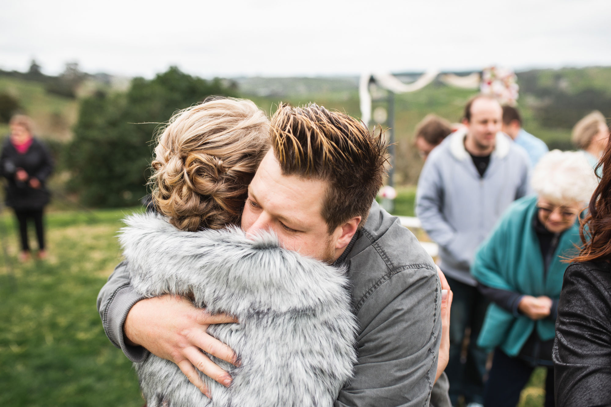 brother hugging the bride