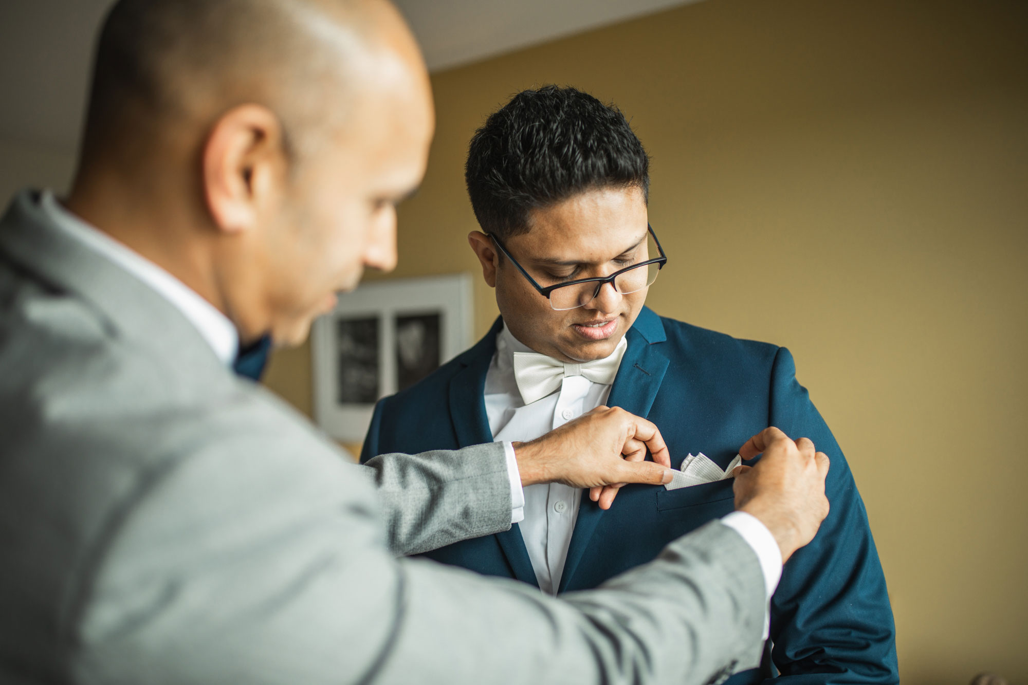 groom putting on button hole