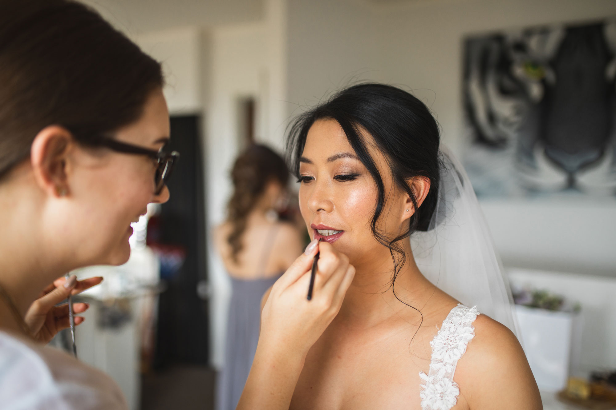 bride putting on lipstick