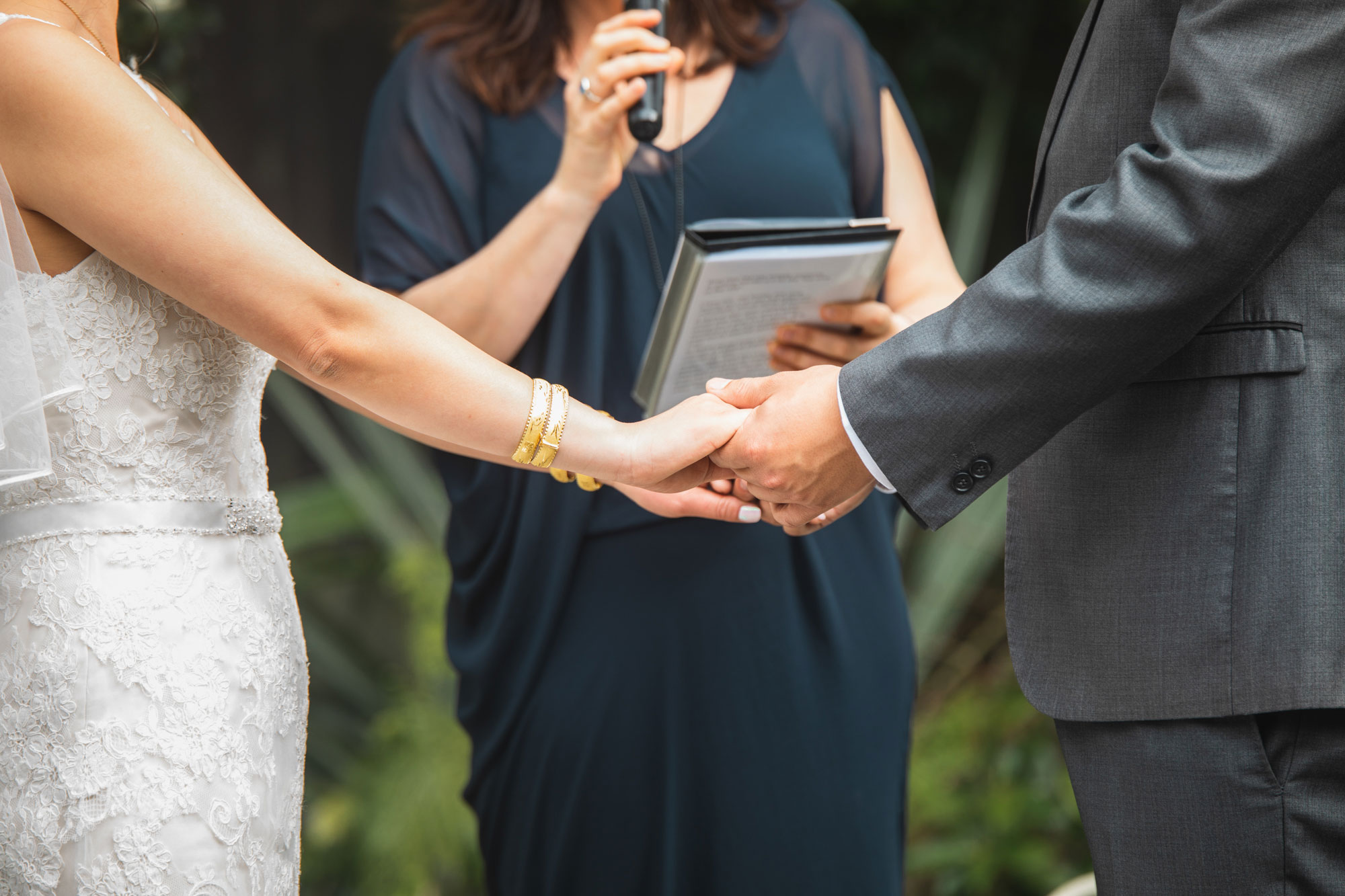 bride and groom holding hands