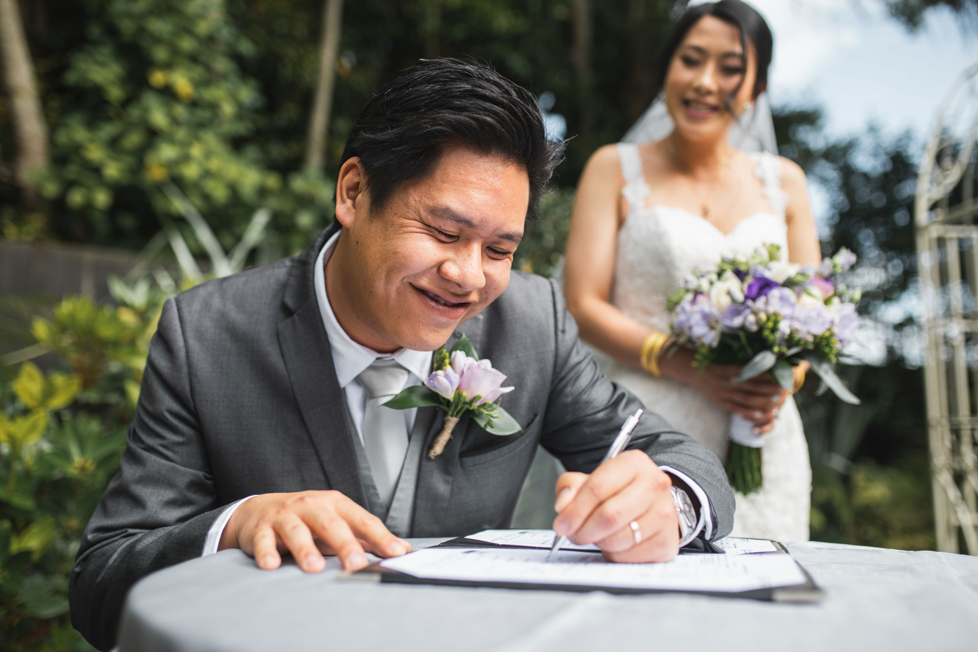 groom signing wedding papers