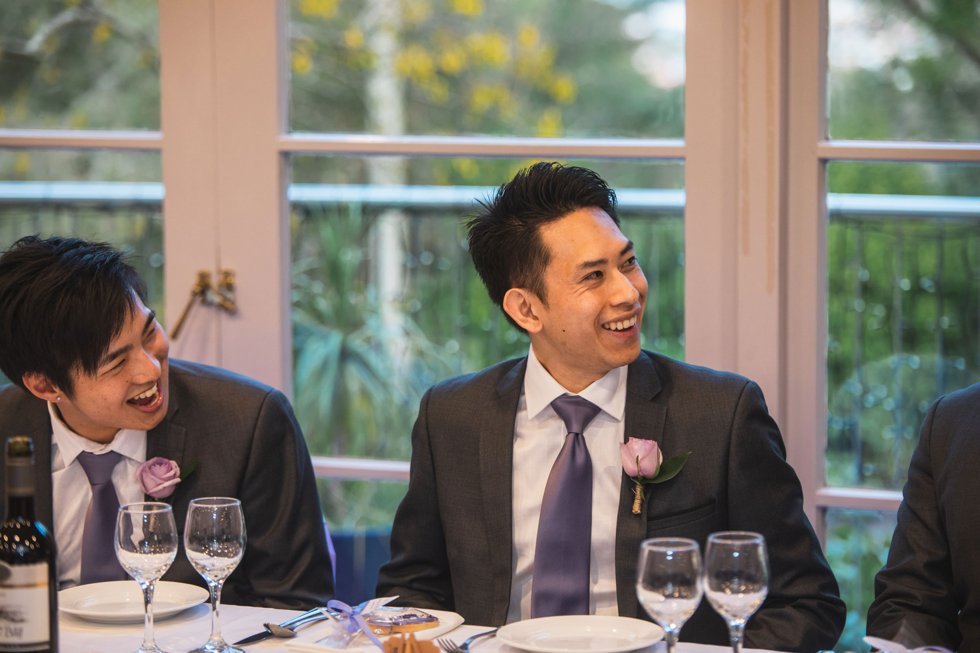 groomsman laughing at reception