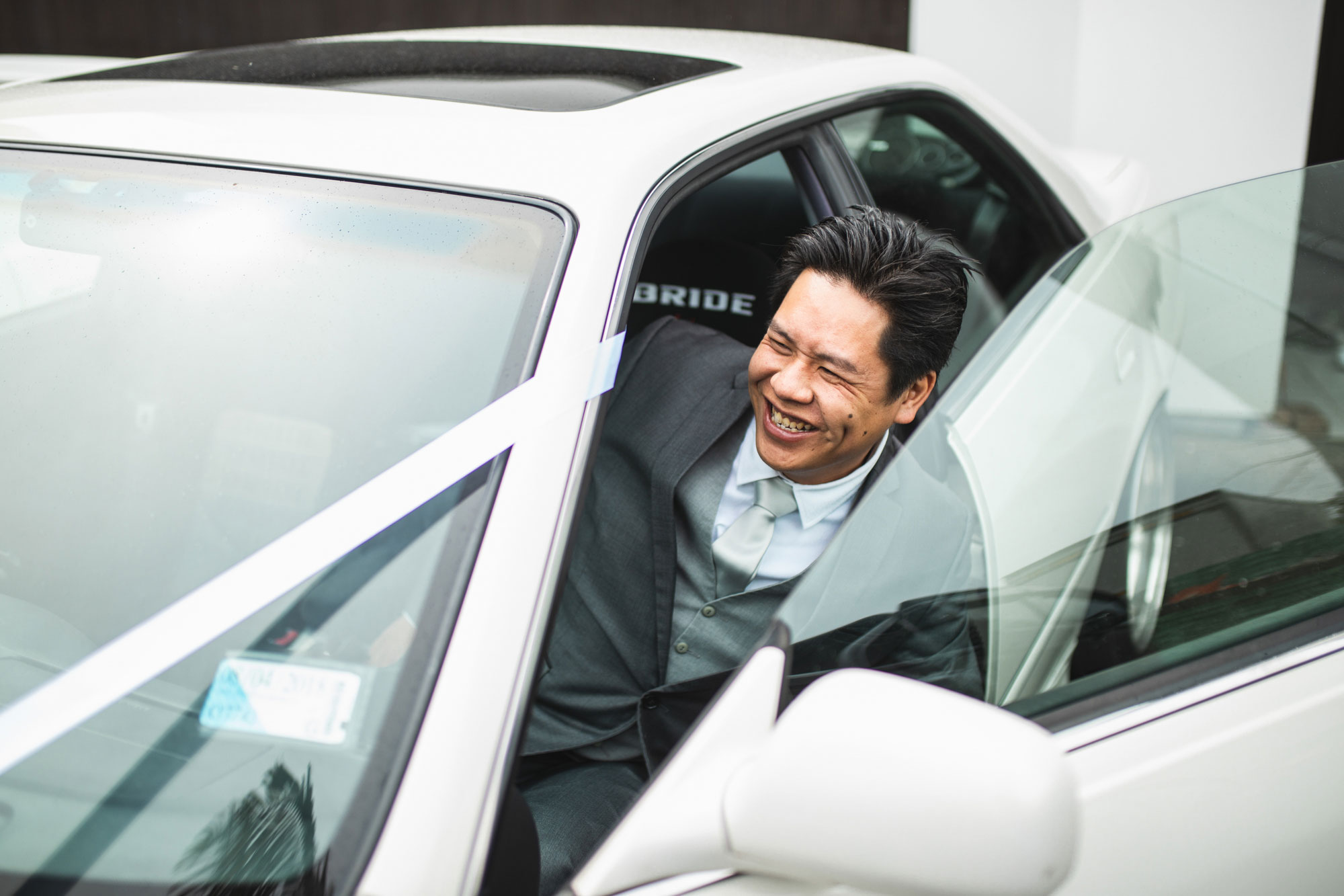 groom getting into wedding car