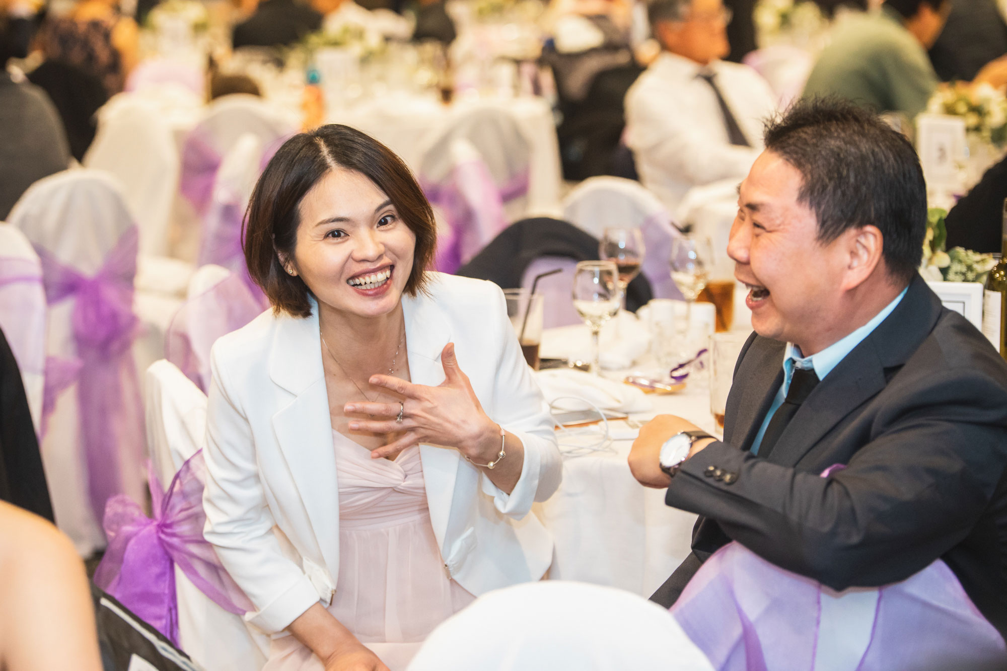 wedding guests laughing at the reception