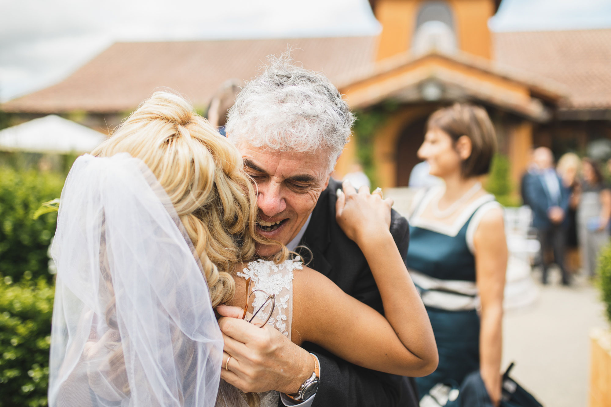 auckland wedding guest hugging bride