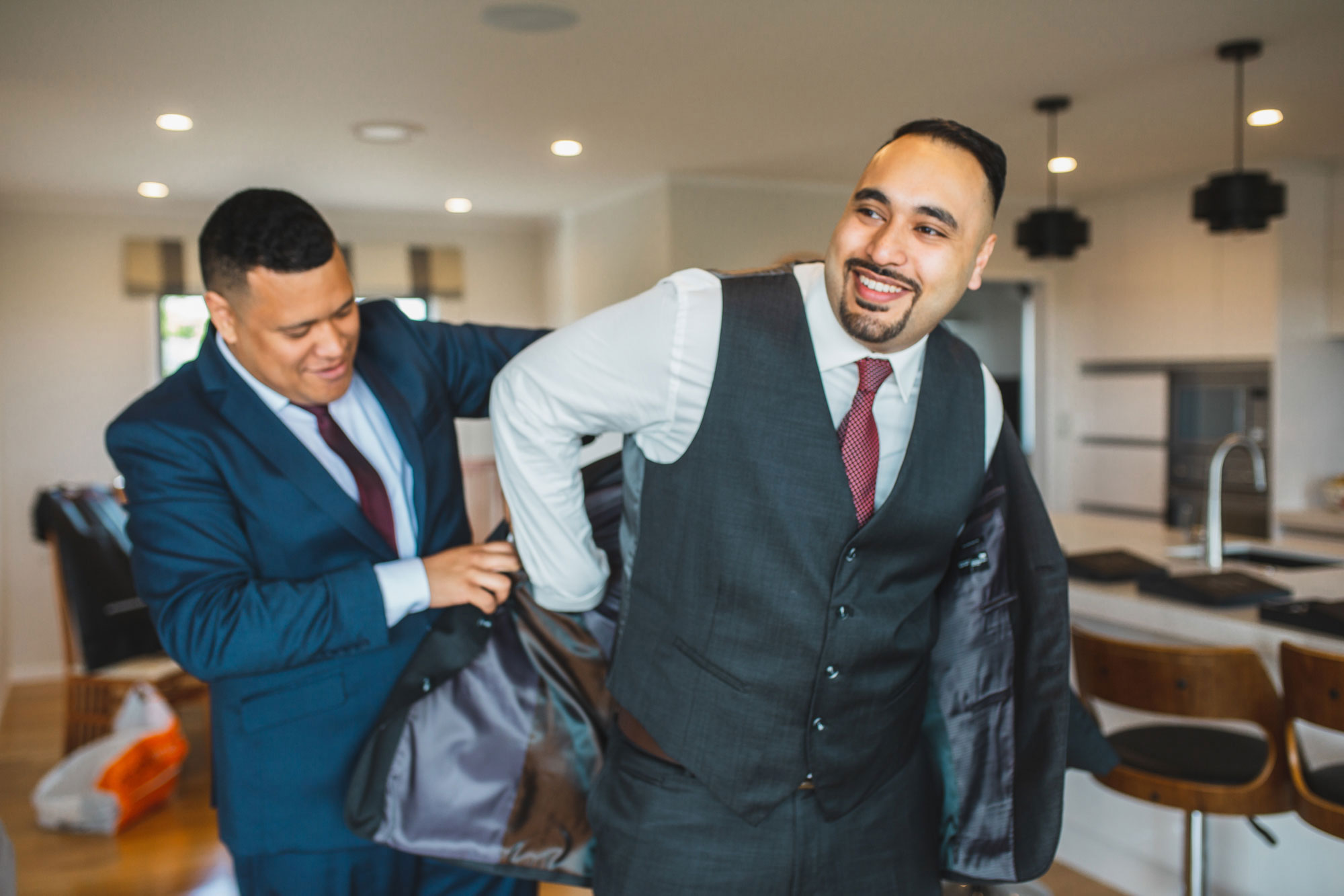 groomsmen putting on jacket