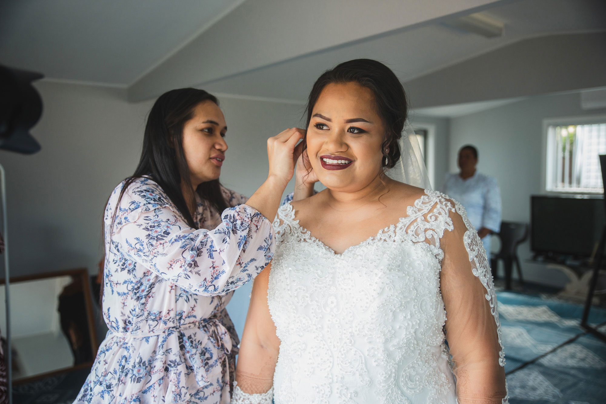 bride putting on earrings