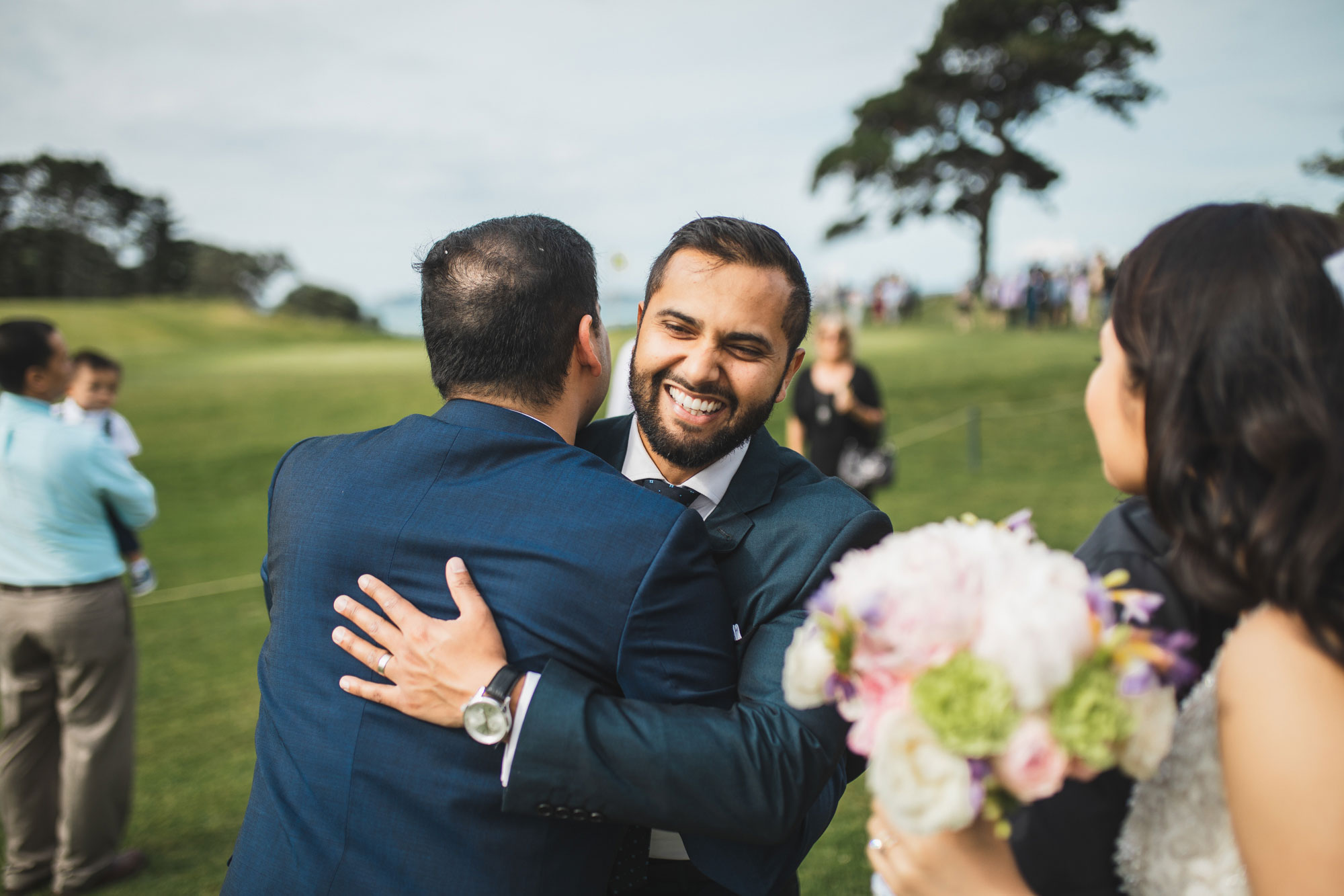 auckland wedding guest hugging