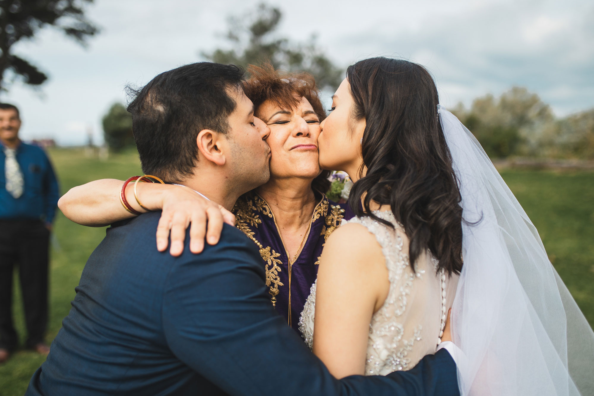auckland wedding bride and groom kissing family