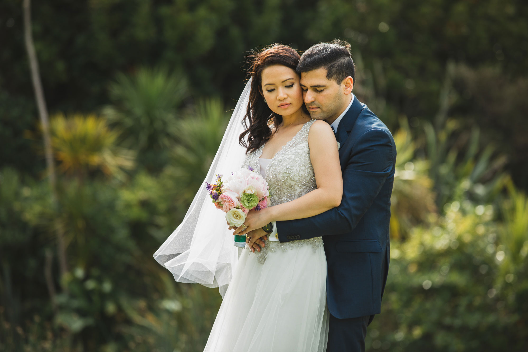 auckland wedding bride hugging groom