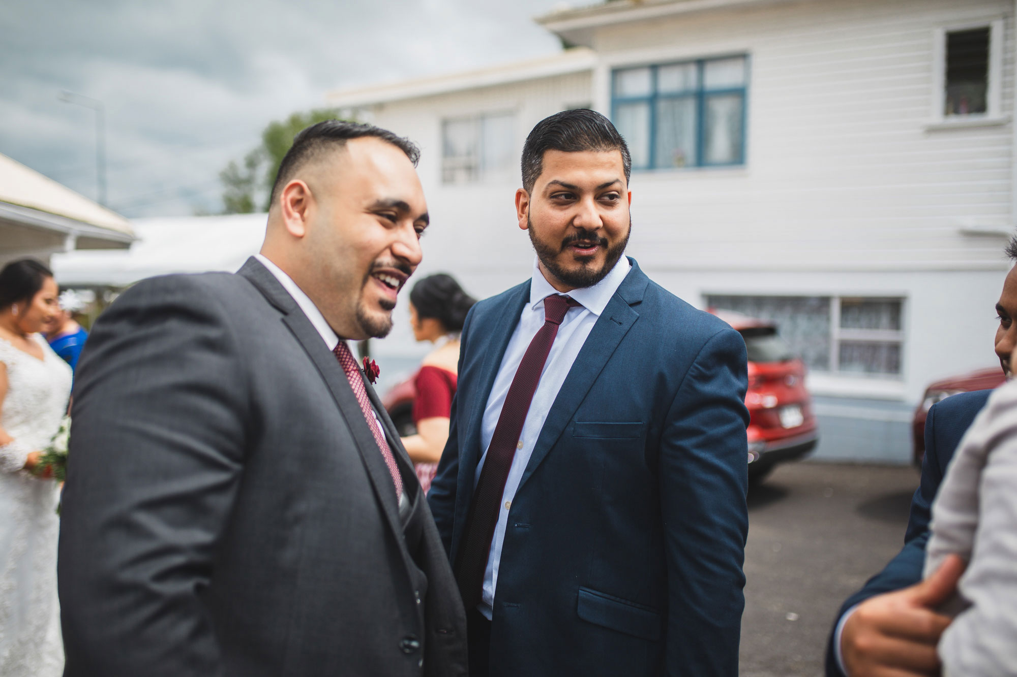 groom and groomsman laughing