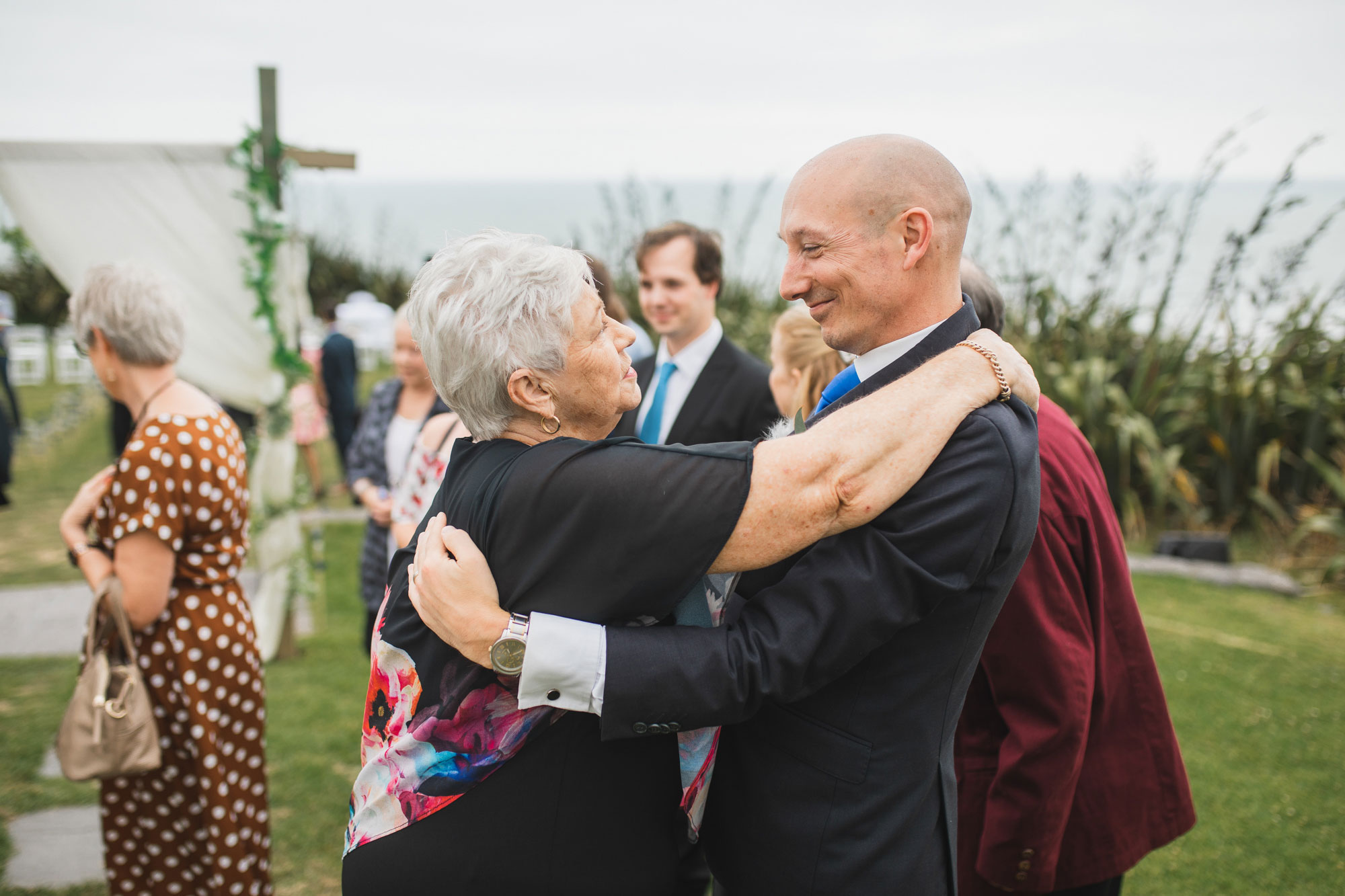 castaways auckland wedding groom and guests embrace