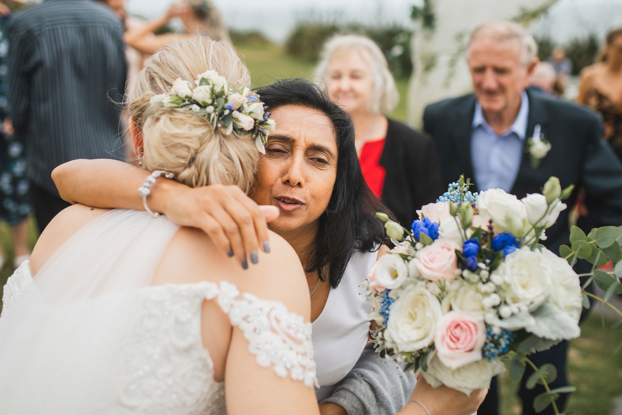 castaways auckland wedding bride and guests embrace
