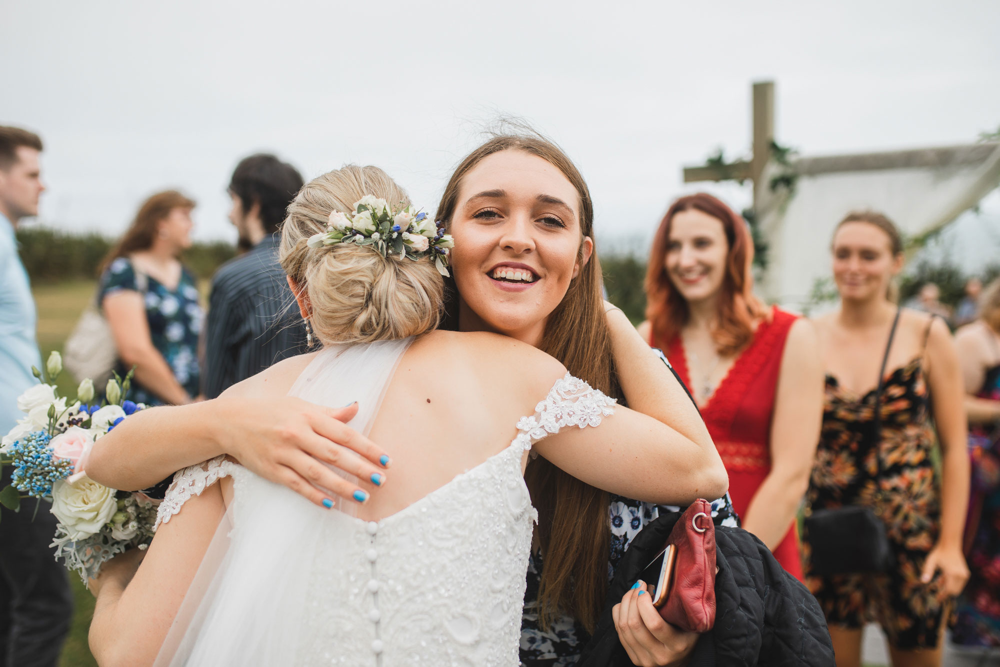 castaways auckland wedding bride hugging guest