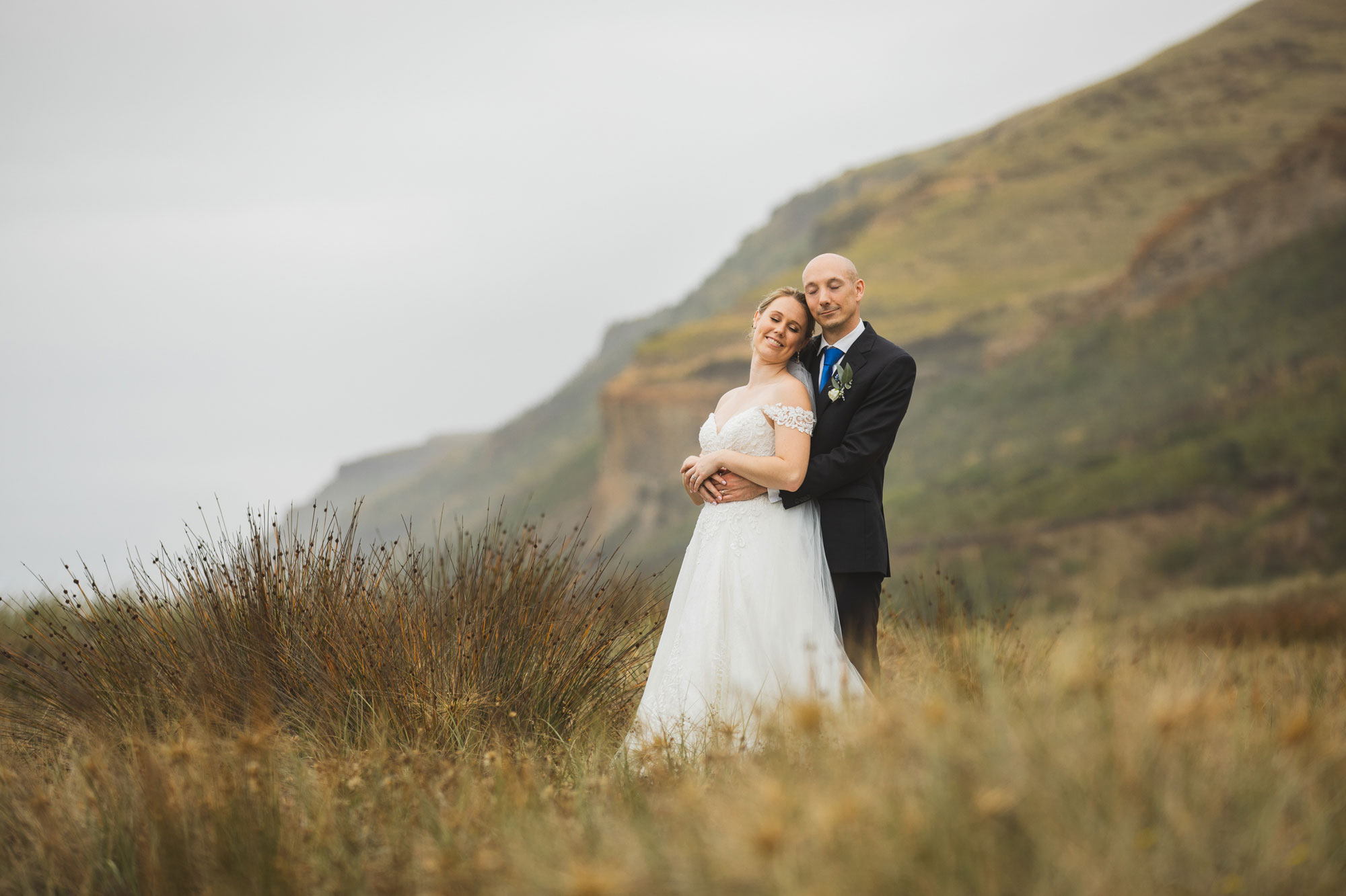 castaways auckland wedding bride and groom embrace