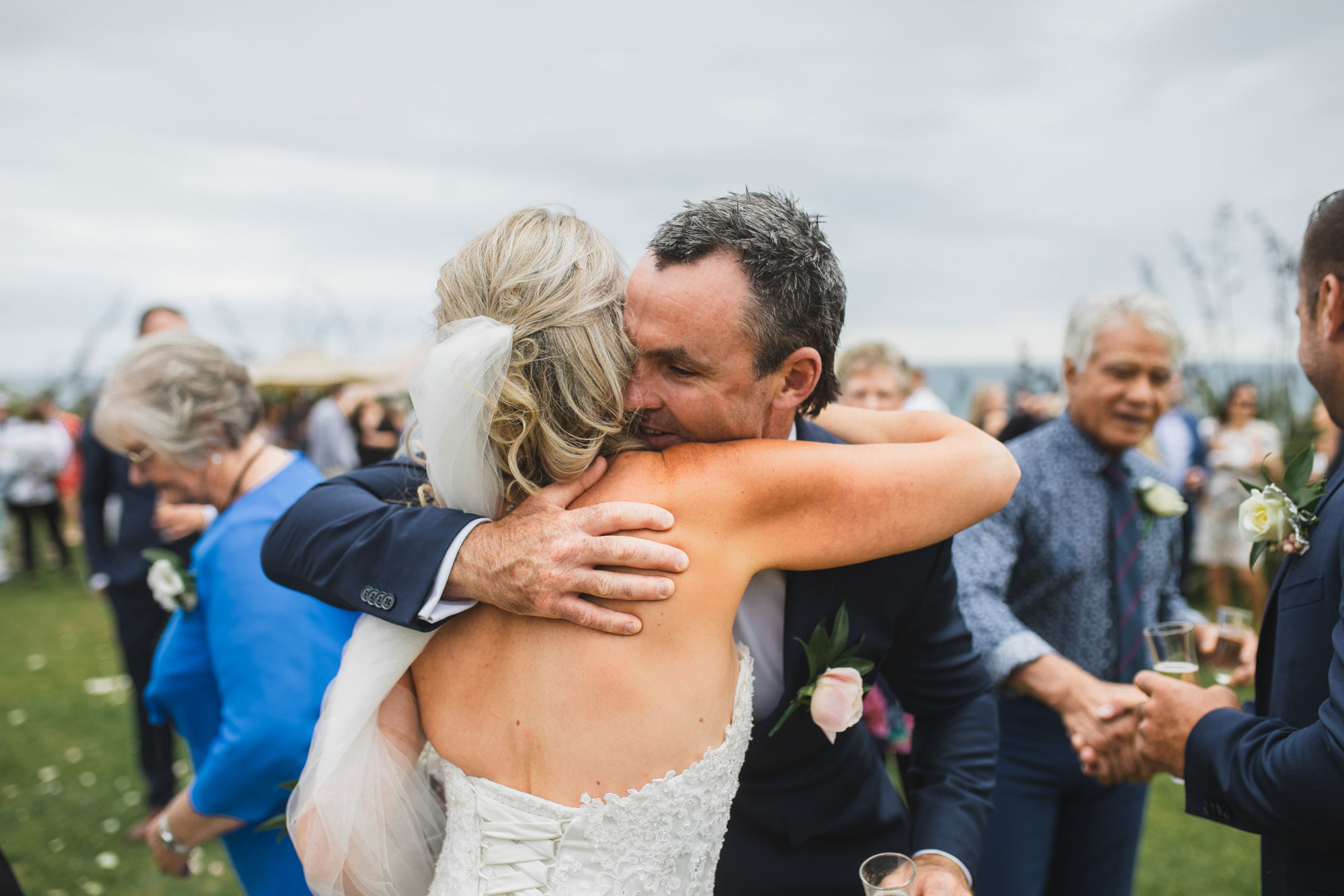 auckland castaways wedding guest hugging bride