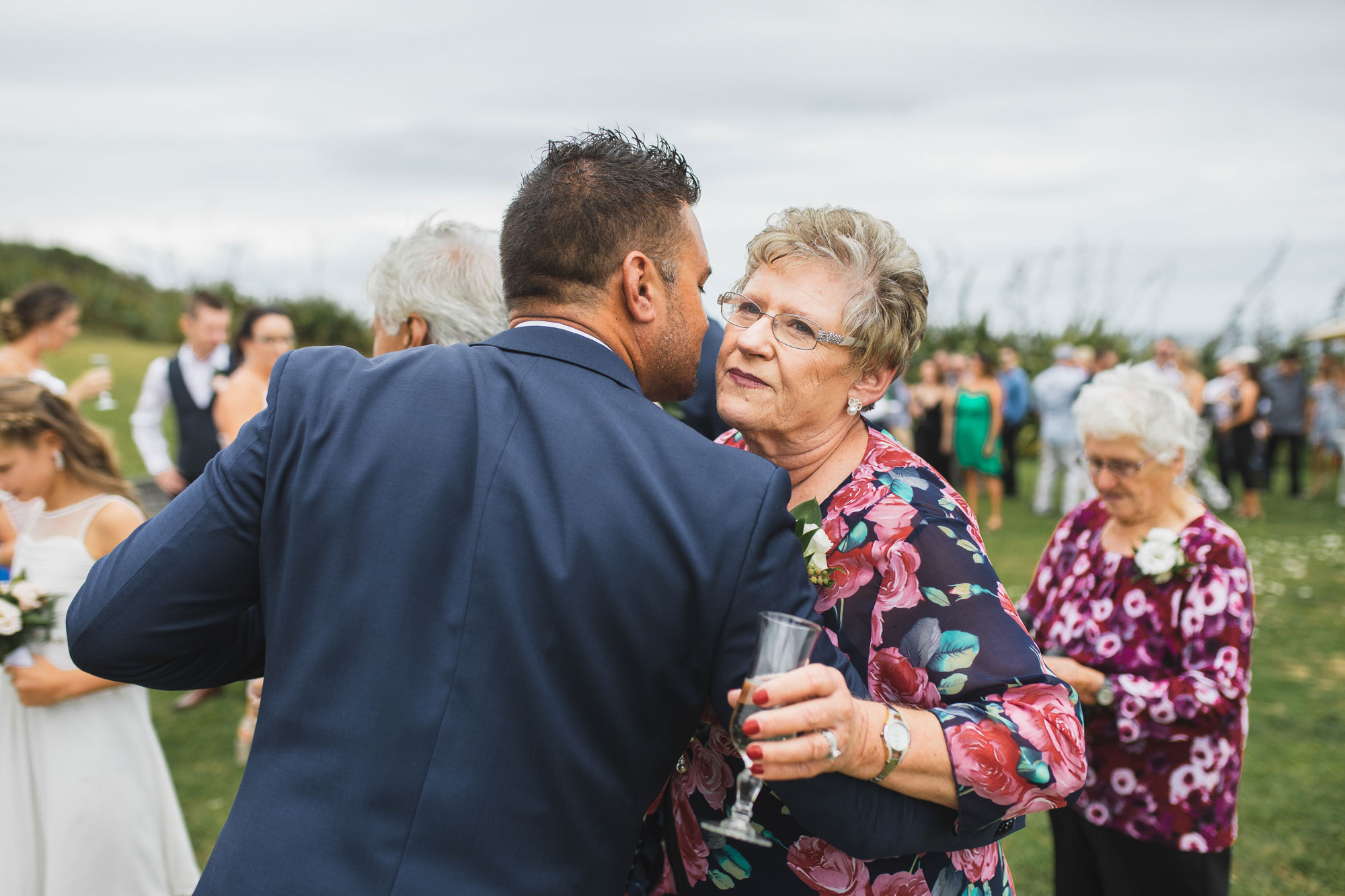 auckland castaways wedding guest hugging groom