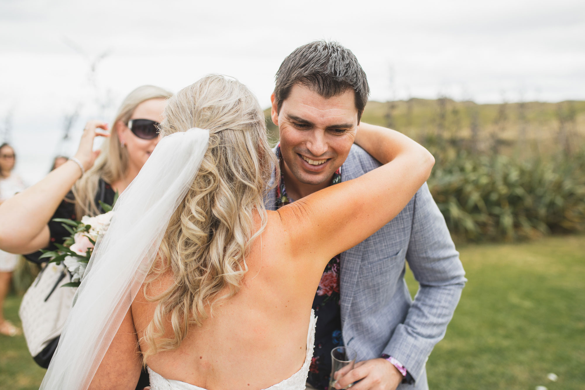 auckland castaways wedding friends hugging