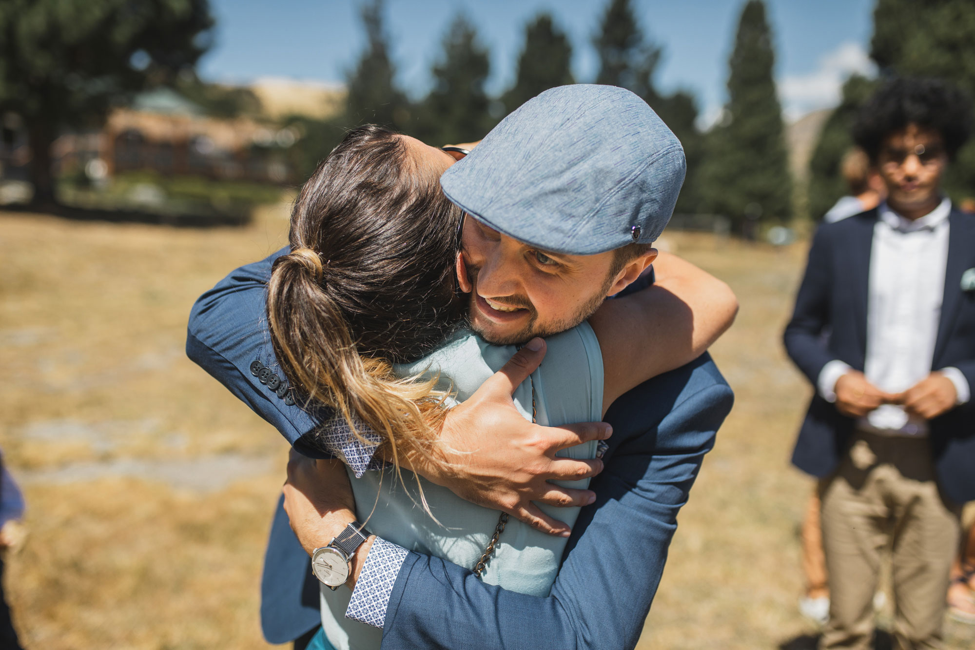 mt. potts lodge wedding groom hugging friend