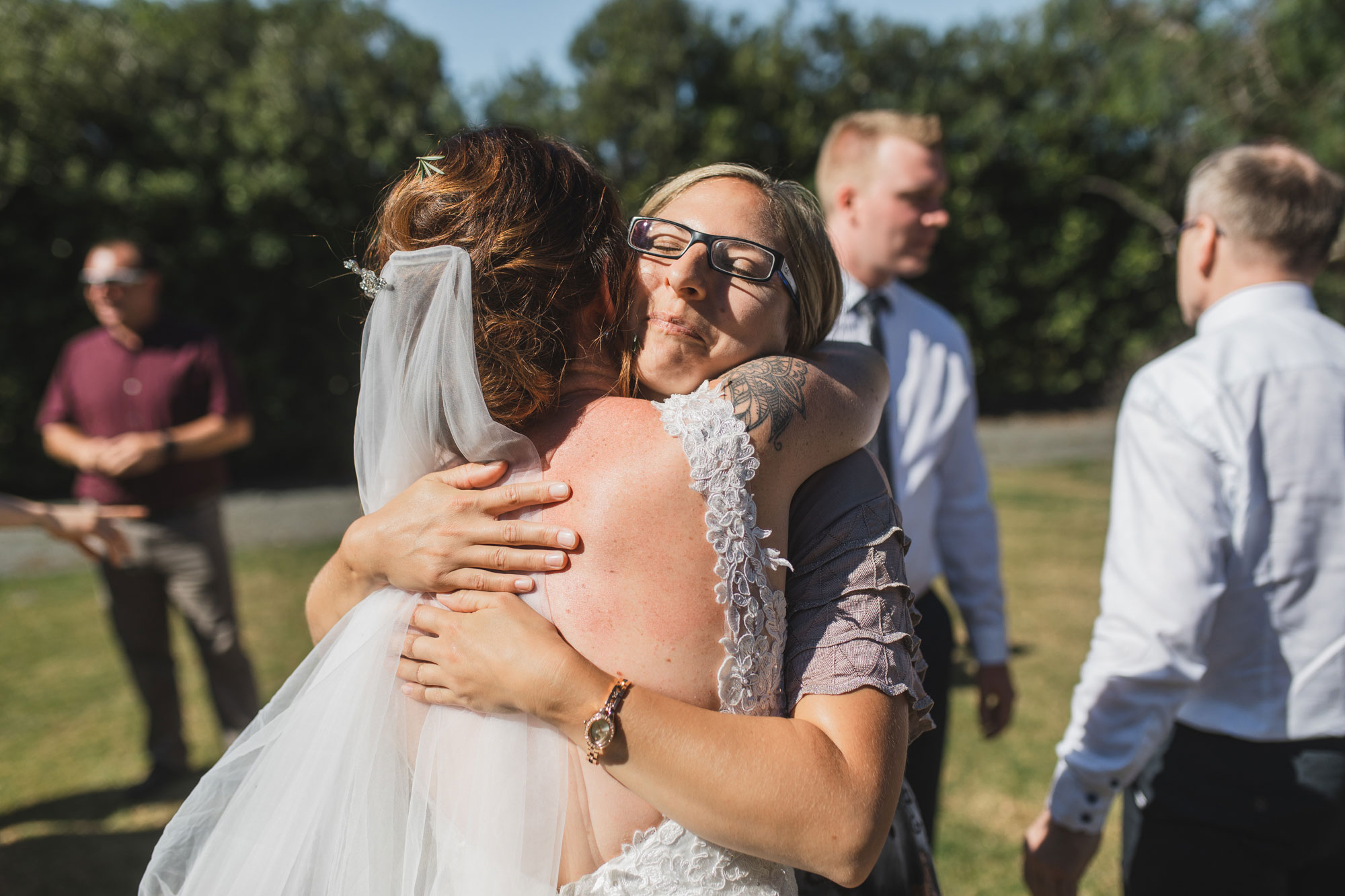 auckland tawharanui lodge wedding guests hugging the bride