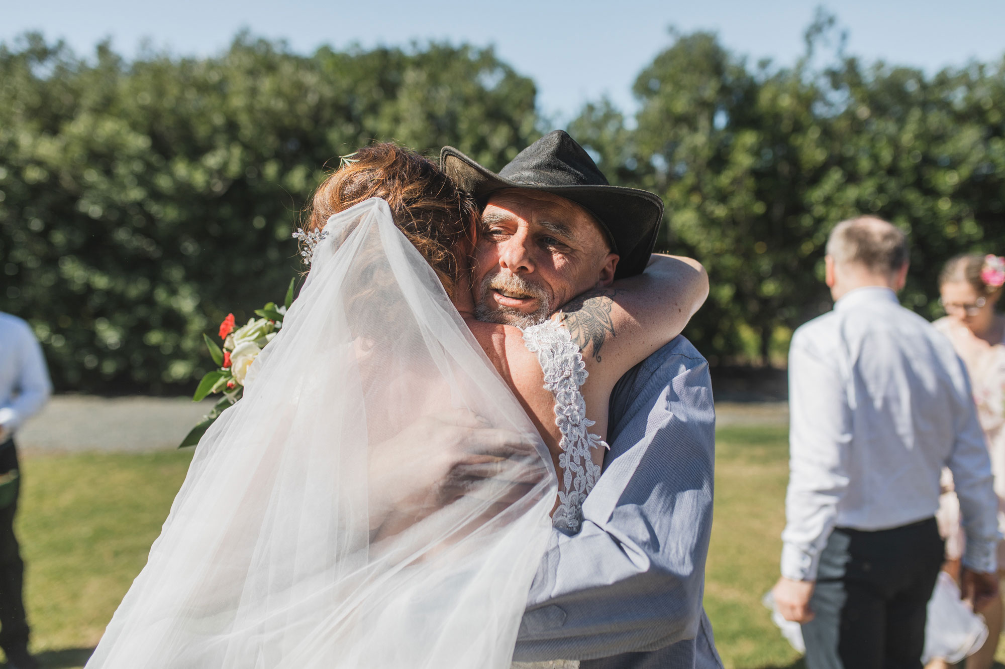 auckland tawharanui lodge wedding father hugging the bride