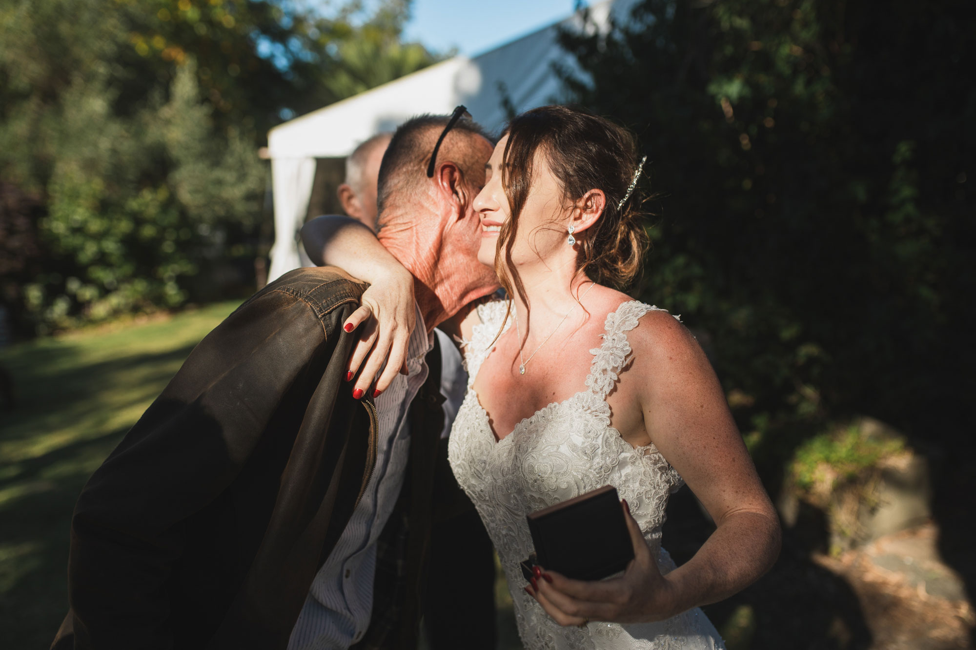 auckland tawharanui lodge wedding bride and father embrace