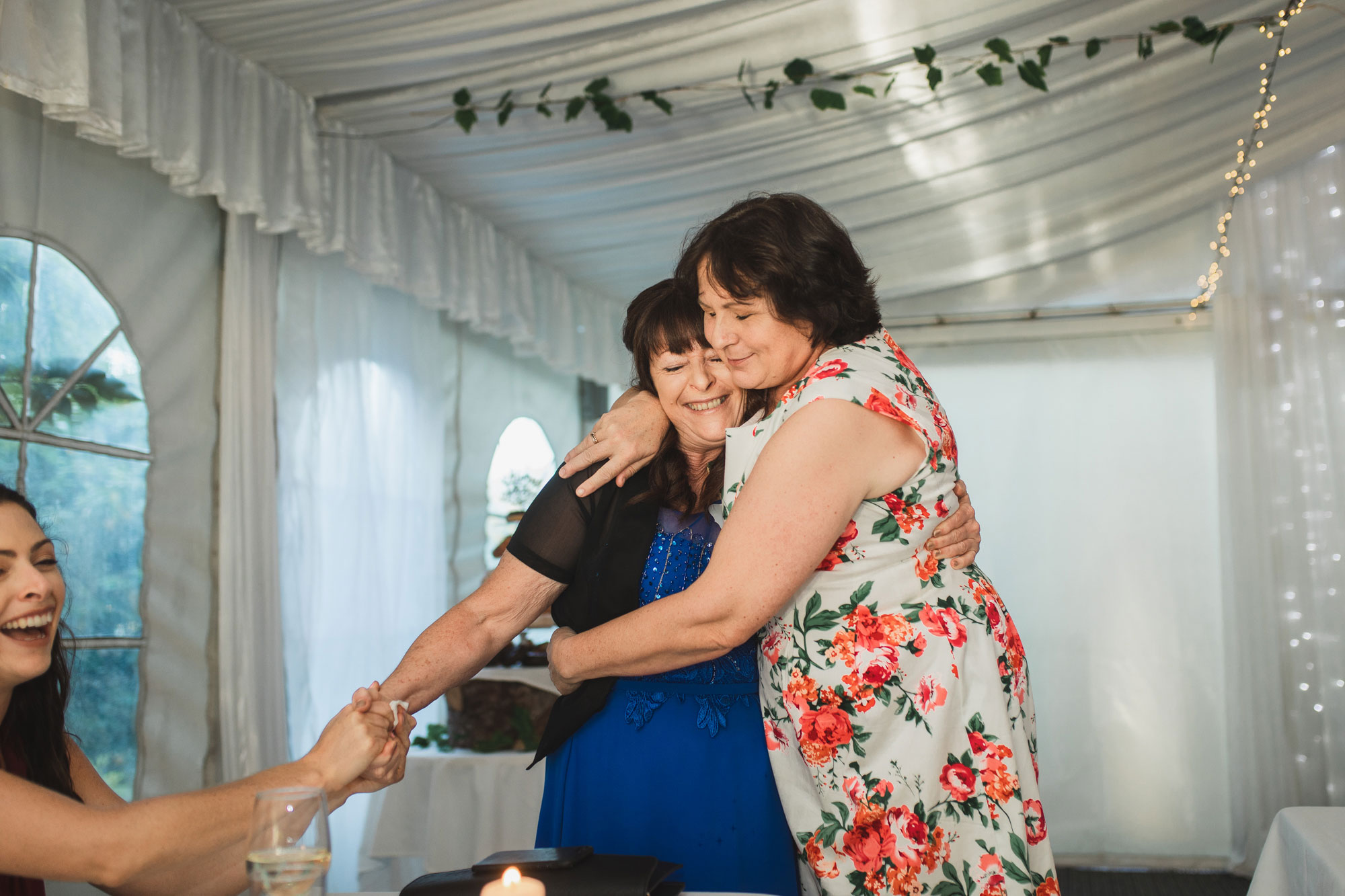 auckland tawharanui lodge wedding mothers holding each other