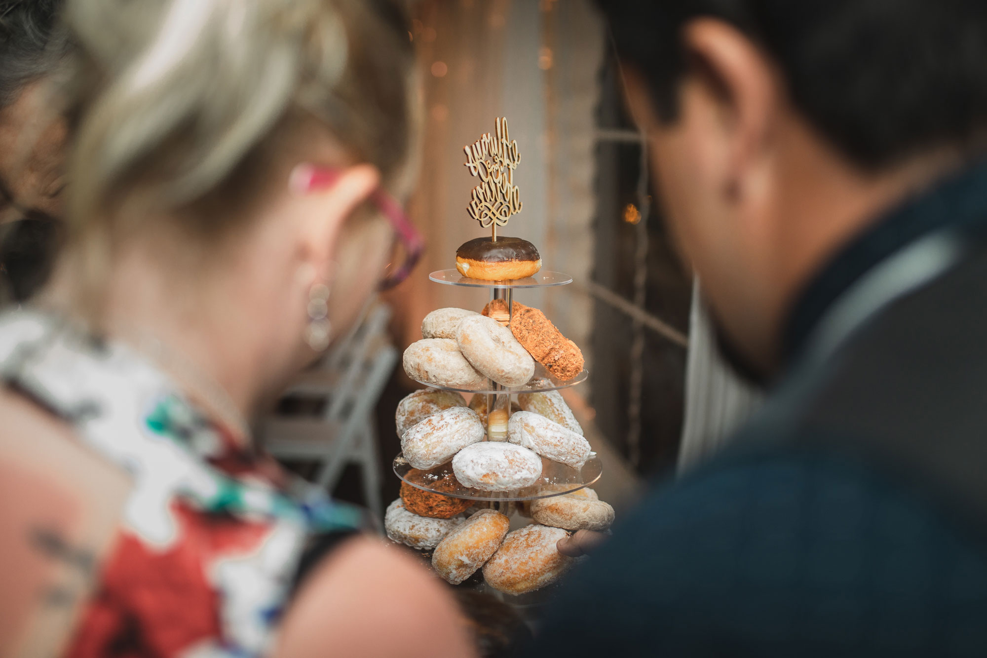 auckland tawharanui lodge wedding guests picking donuts