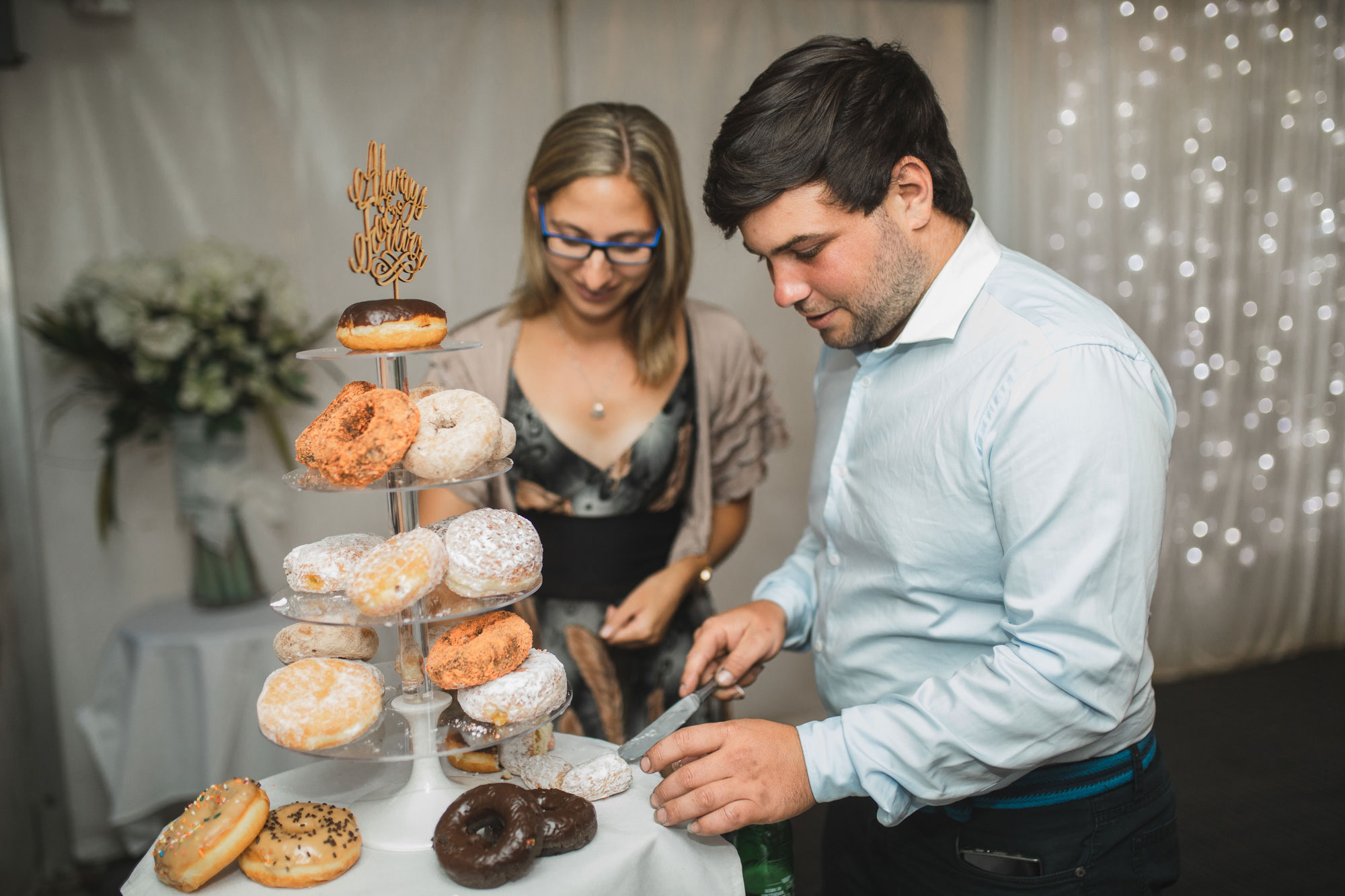 auckland tawharanui lodge wedding guests choosing donuts