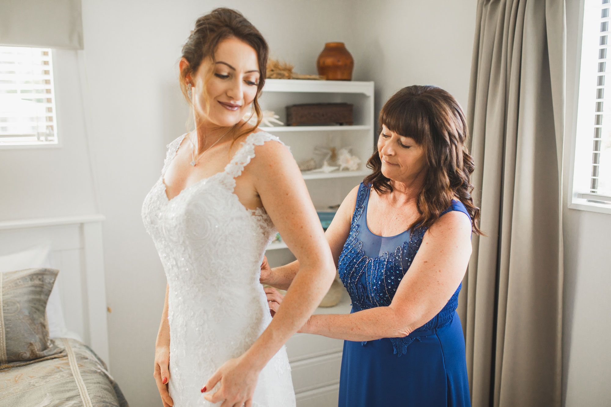 auckland wedding bride and mother putting on dress
