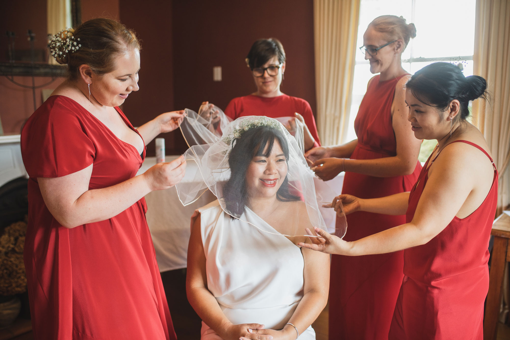 auckland wedding bride putting on veil