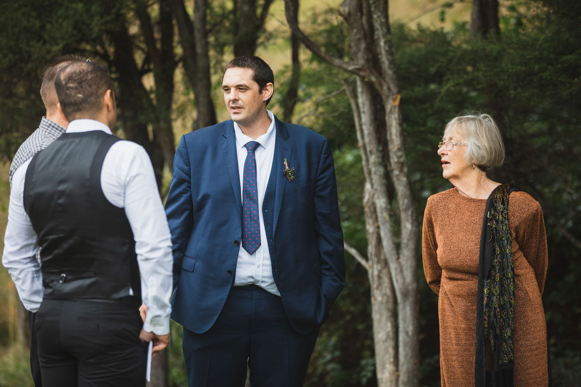 auckland waterfall farm wedding groomsman talking