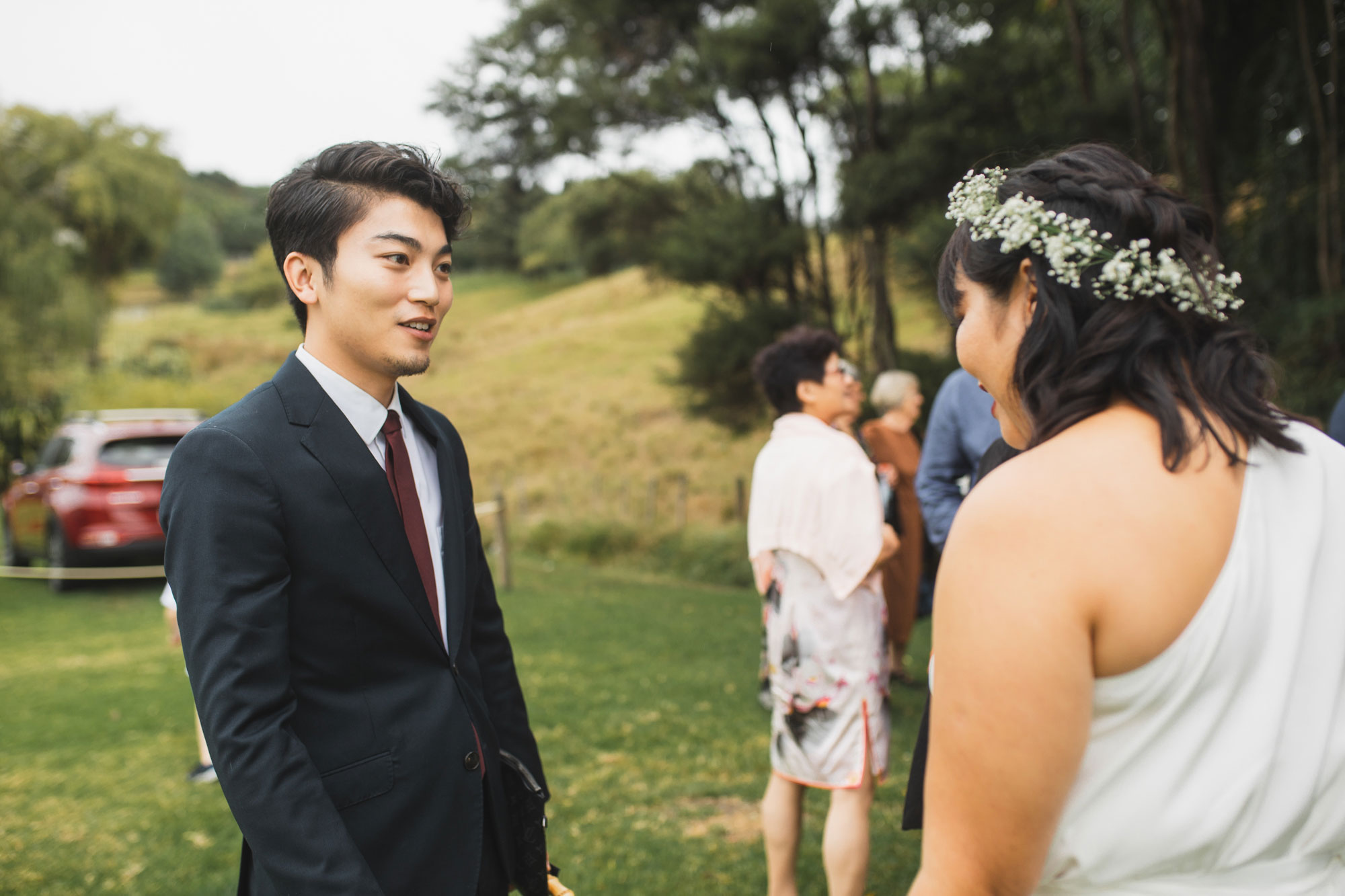 auckland waterfall farm wedding guest talking to bride