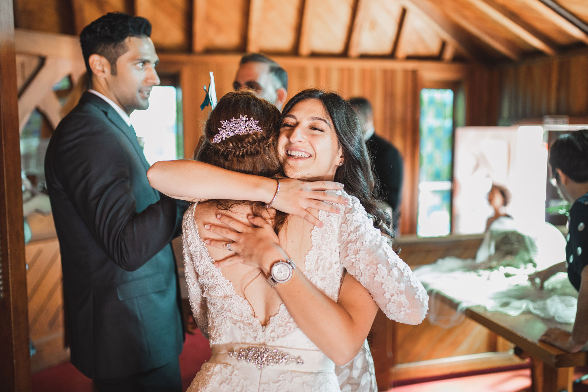 wedding guest and bride hugging