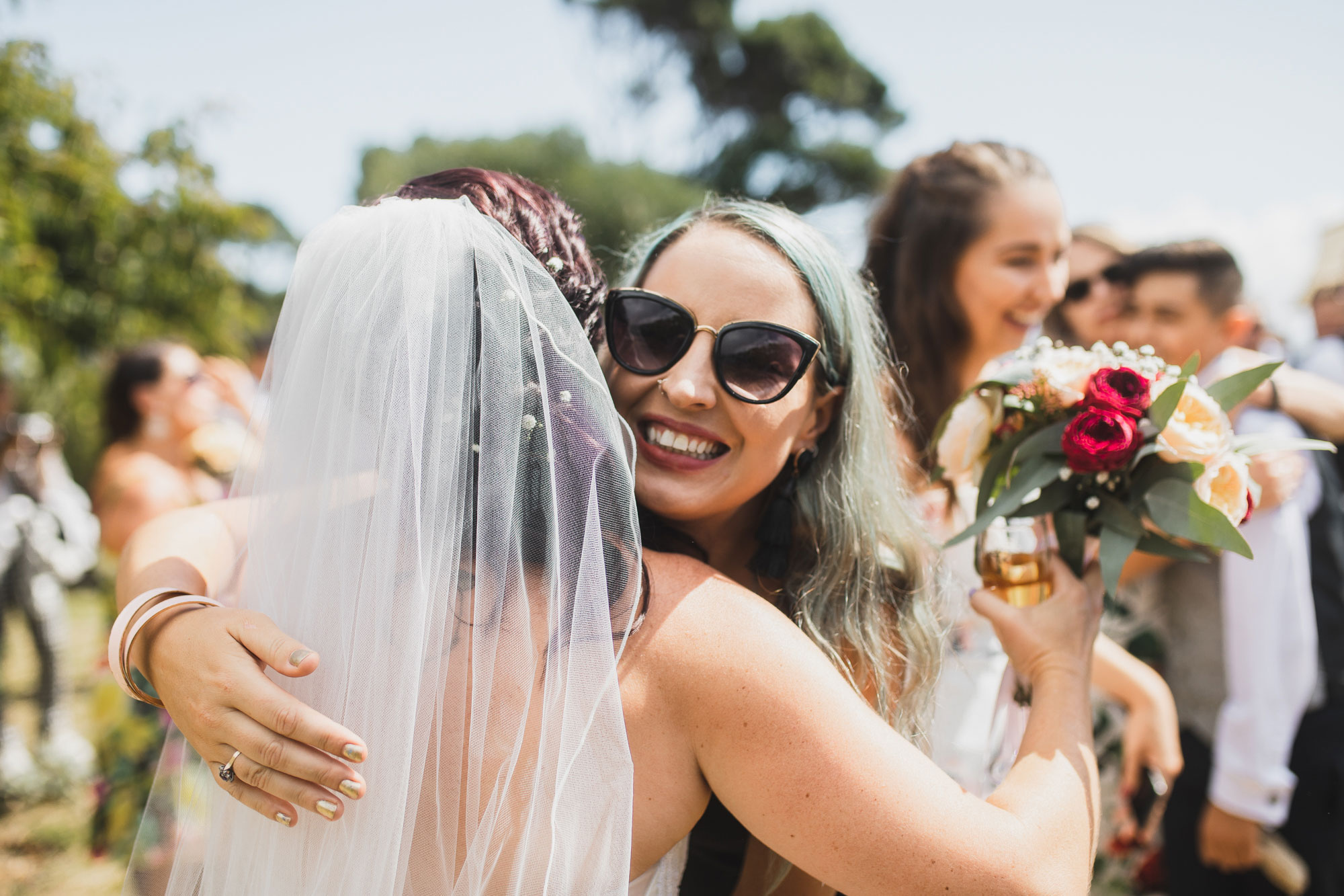 auckland wedding guest hugging bride