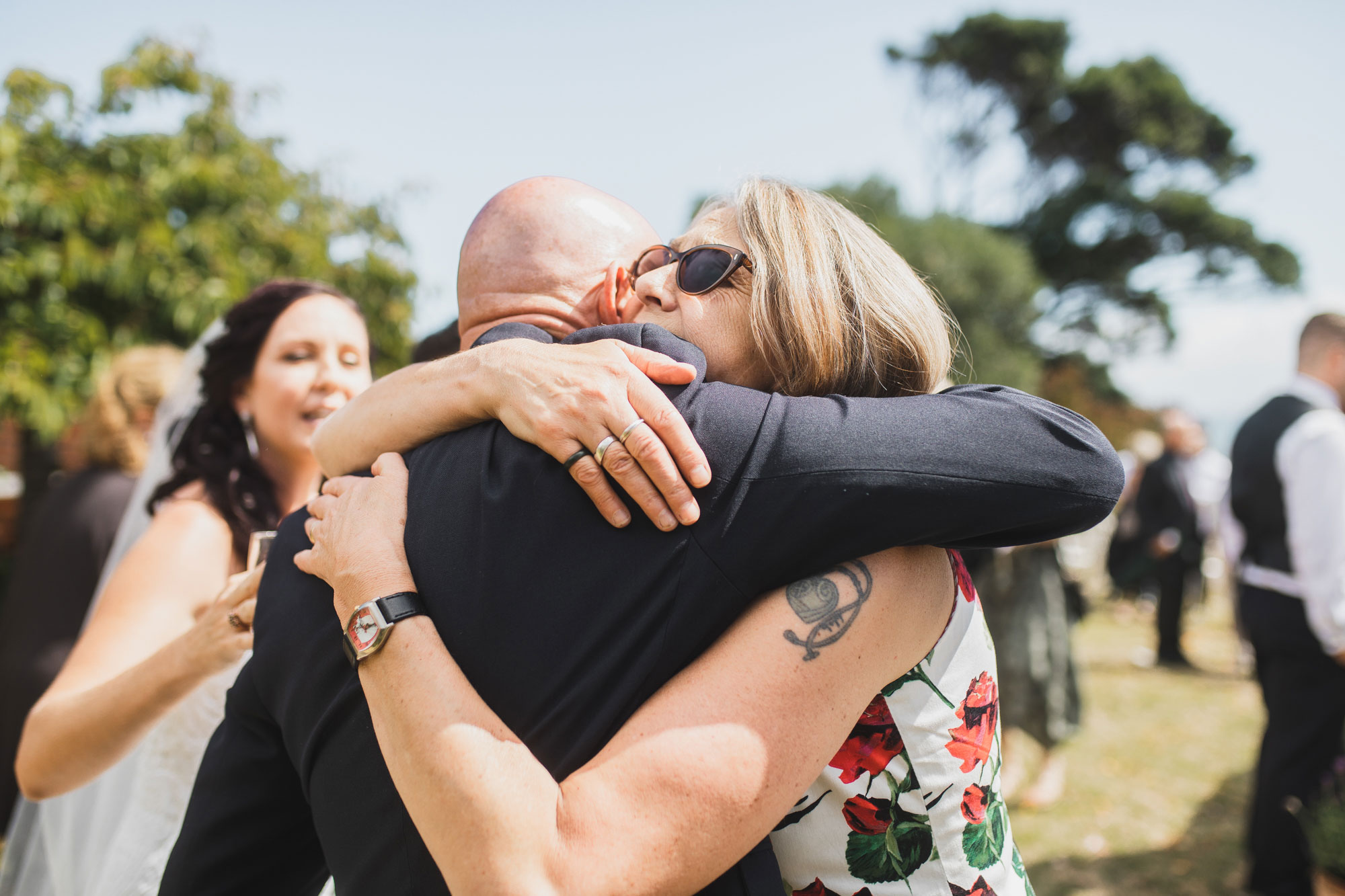 groom embracing wedding guest