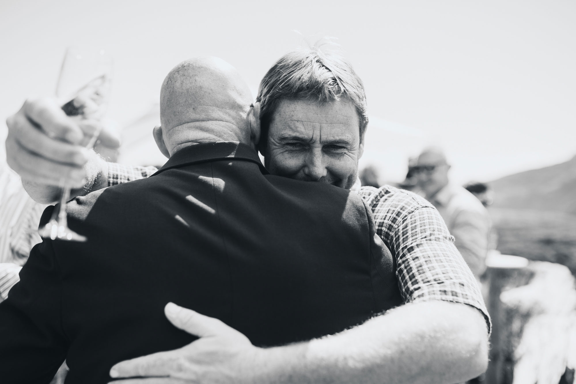 groom and guest embrace